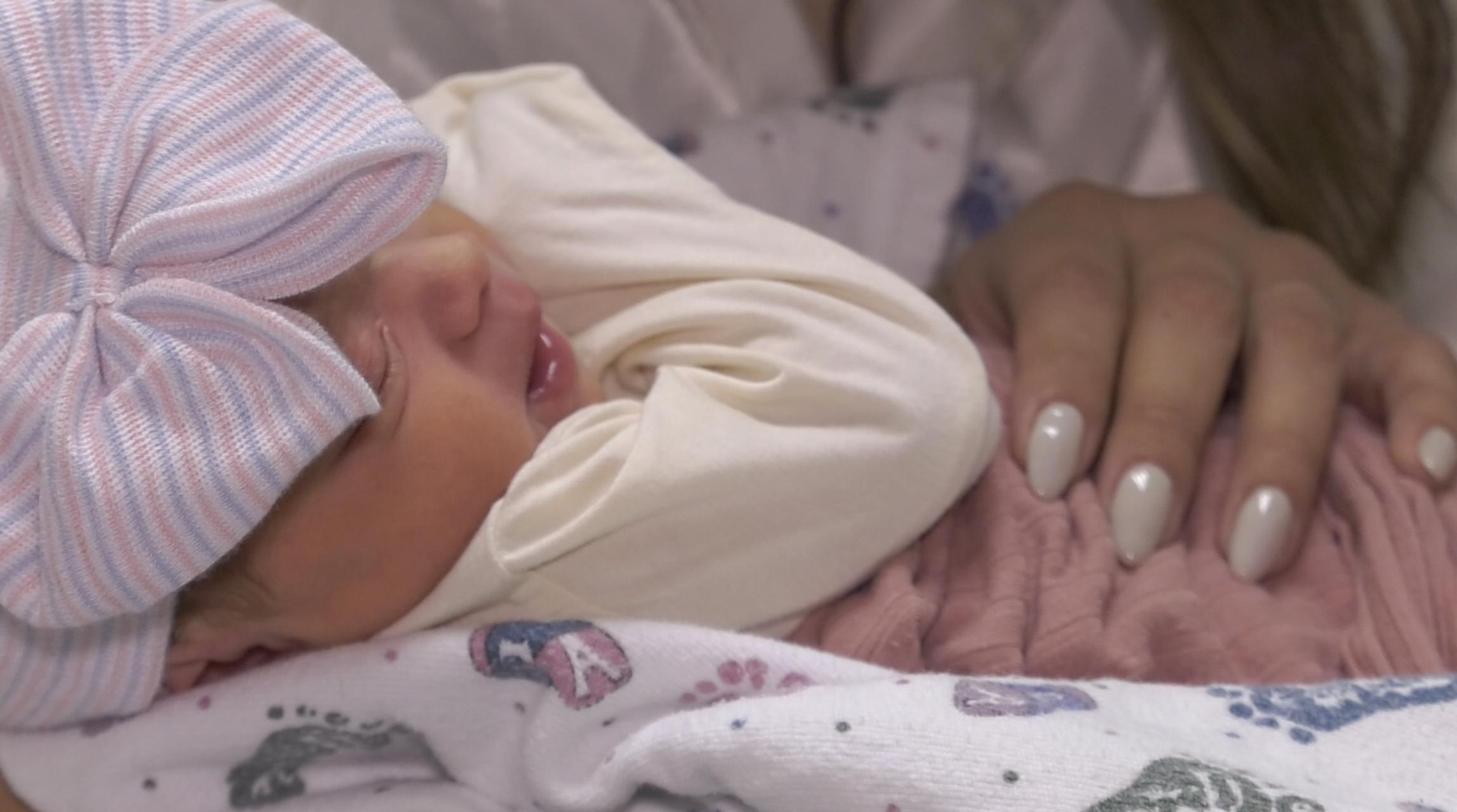 Newborn baby Luna Grace Lowe is shown being held by her mother Vannessa Lowe on Friday. She gave birth to the newborn on the side of the I-15 freeway in Murray Thursday evening.