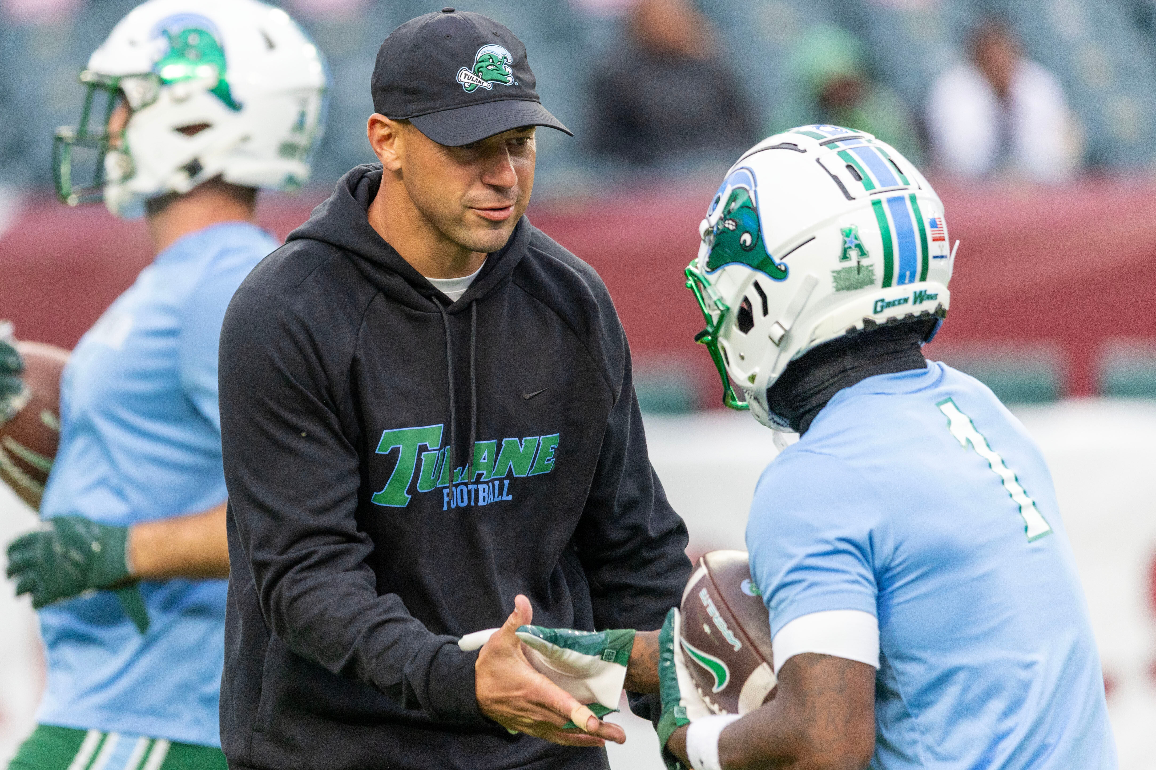 Tulane head coach Jon Sumrall, front left, talks to players before an NCAA college football game against Temple, Saturday, Nov. 22, 2025, in Philadelphia. 