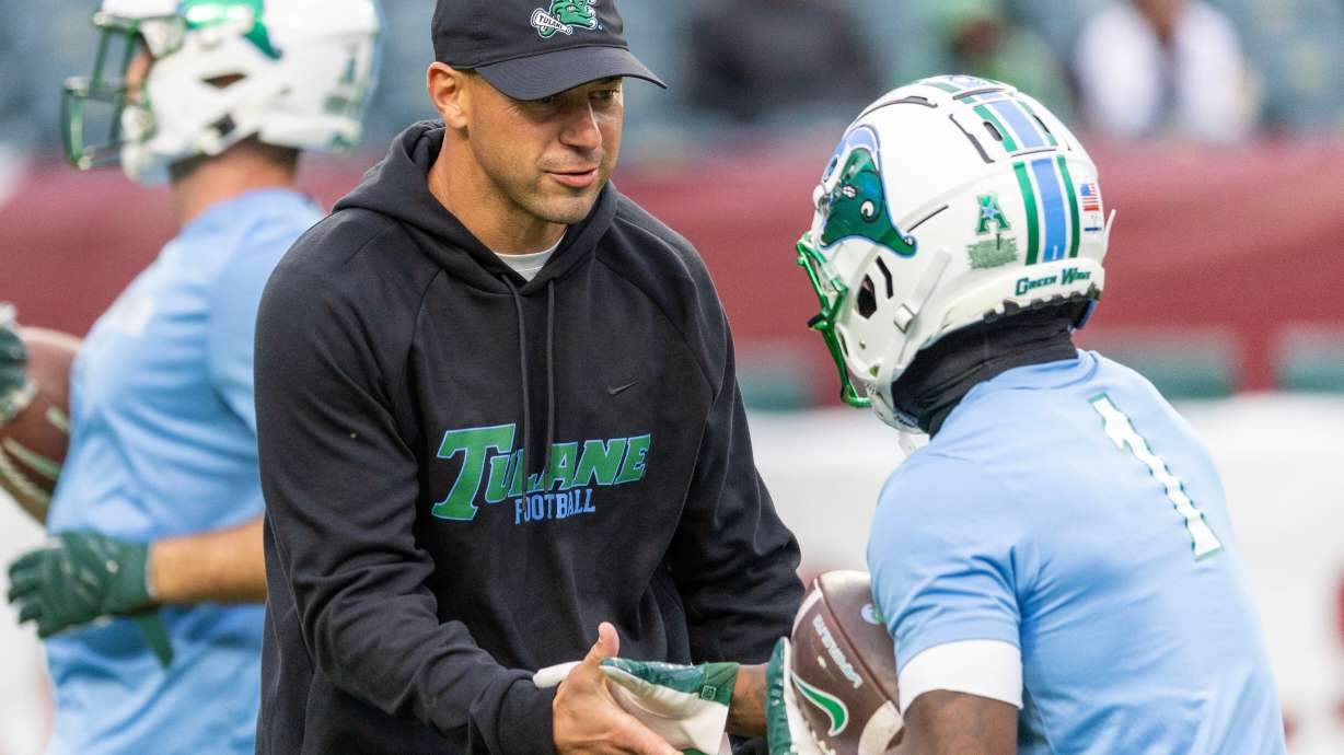 Tulane head coach Jon Sumrall, front left, talks to players before an NCAA college football game against Temple, Saturday, Nov. 22, 2025, in Philadelphia.