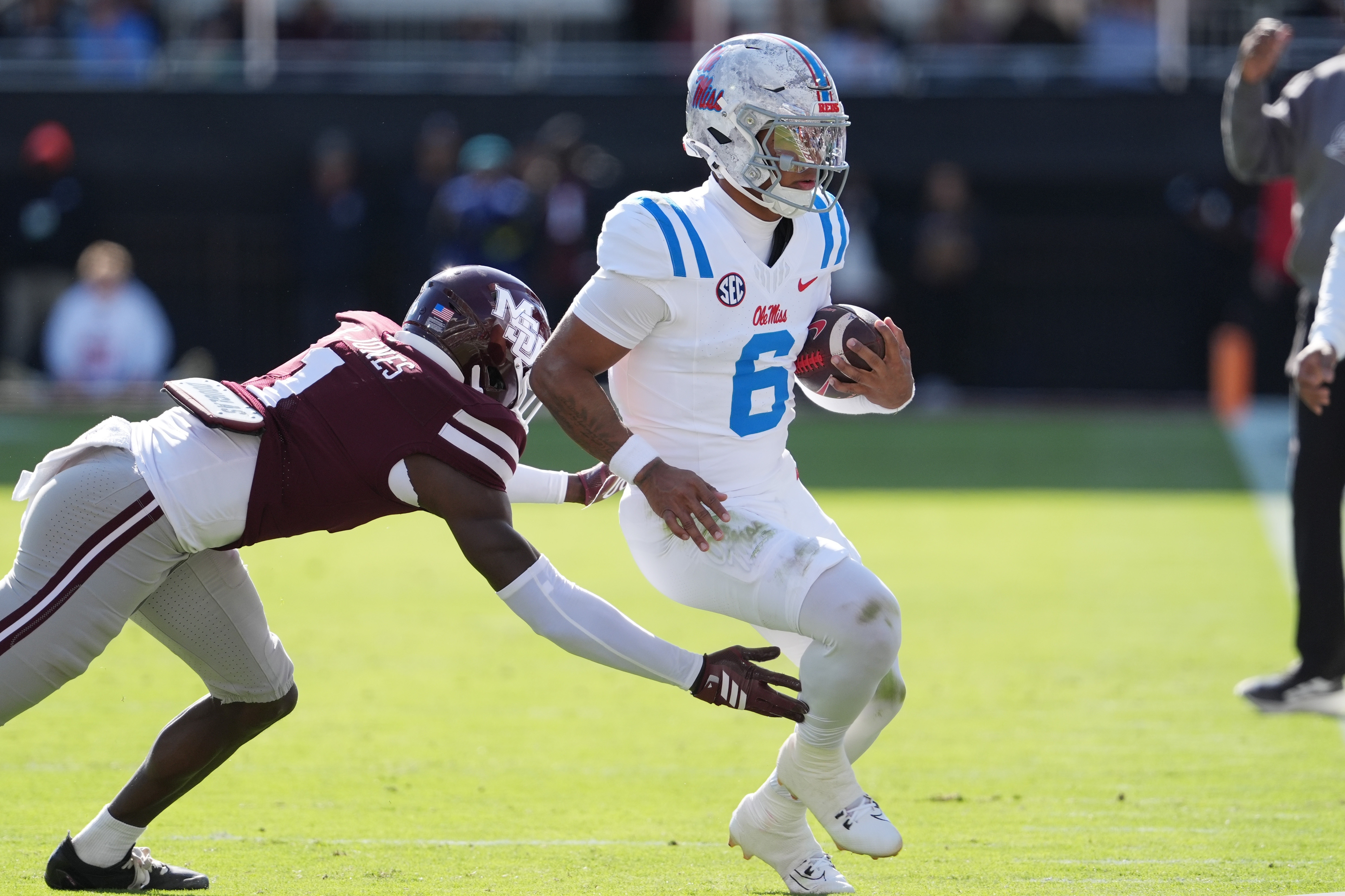 Mississippi quarterback Trinidad Chambliss (6) is pushed out-of-bounds by Mississippi State cornerback Kelley Jones (1) during the first half of an NCAA college football game Frifday, Nov. 28, 2025, in Starkville, Miss. 