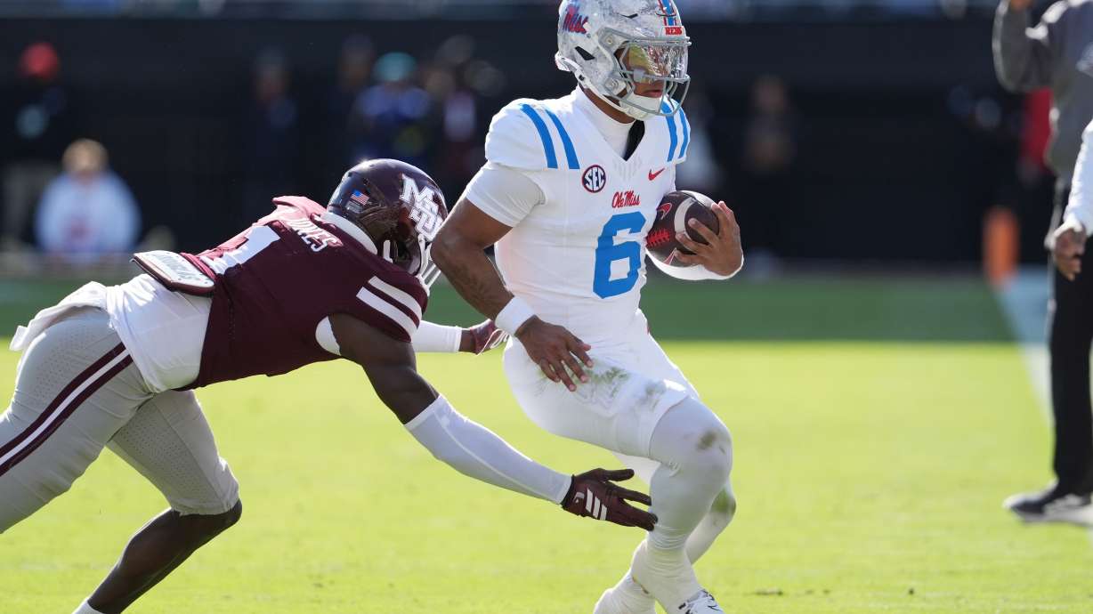 Mississippi quarterback Trinidad Chambliss (6) is pushed out-of-bounds by Mississippi State cornerback Kelley Jones (1) during the first half of an NCAA college football game Frifday, Nov. 28, 2025, in Starkville, Miss.