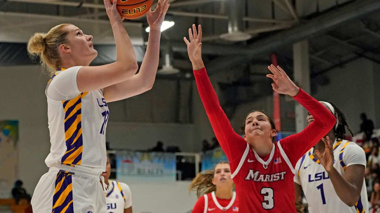 LSU forward Kate Koval, left, looks to shoot a jump shot over Marist guard Justine Henry (3) during the second quarter of an NCAA college basketball game at the Paradise Jam tournament Friday, Nov. 28, 2025, in St. Thomas, U.S. Virgin Islands.