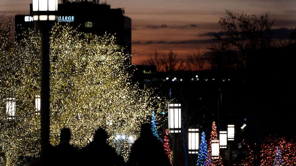 People look at the Christmas lights surrounding the Conference Center in Salt Lake City on Friday.