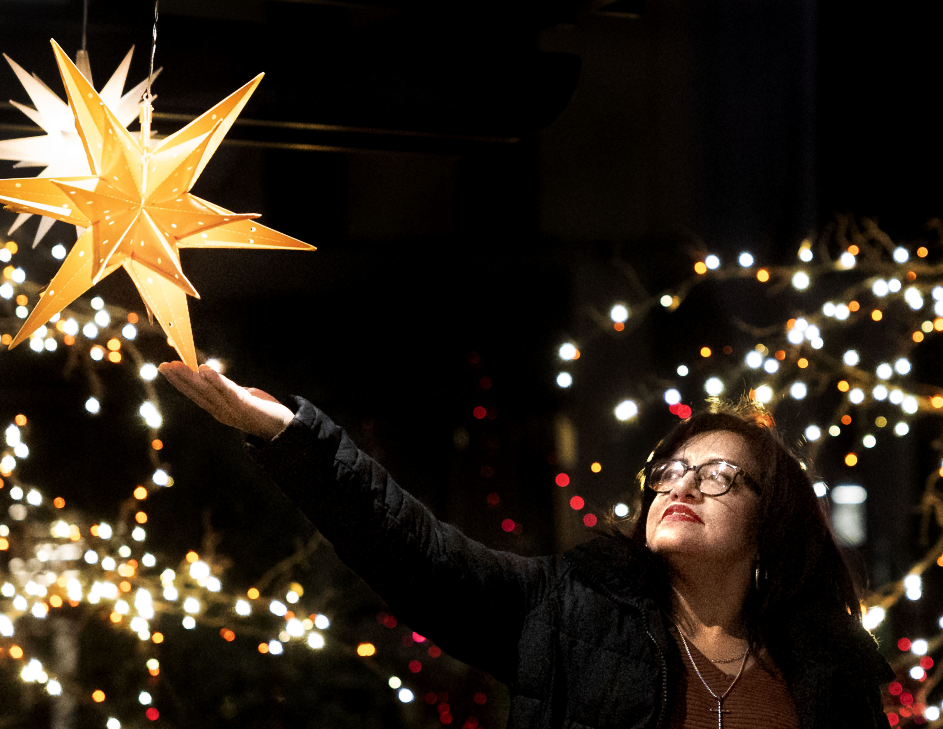 Claudia Molina of Denver admires a hanging star in Salt Lake City’s Temple Square on Friday.