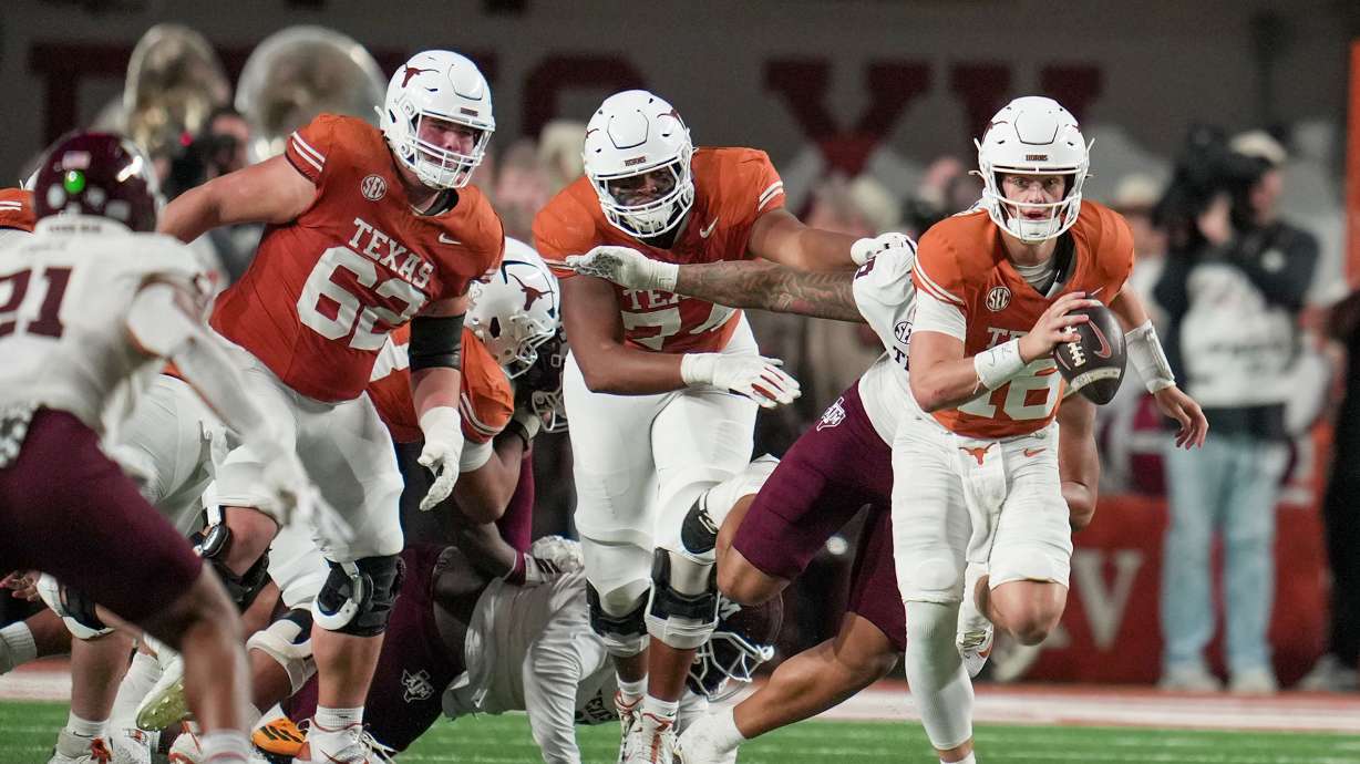 Texas quarterback Arch Manning (16) looks for room to run against Texas A&M defense during the first half of an NCAA college football game in the Lone Star Showdown in Austin, Texas, Friday, Nov. 28, 2025.