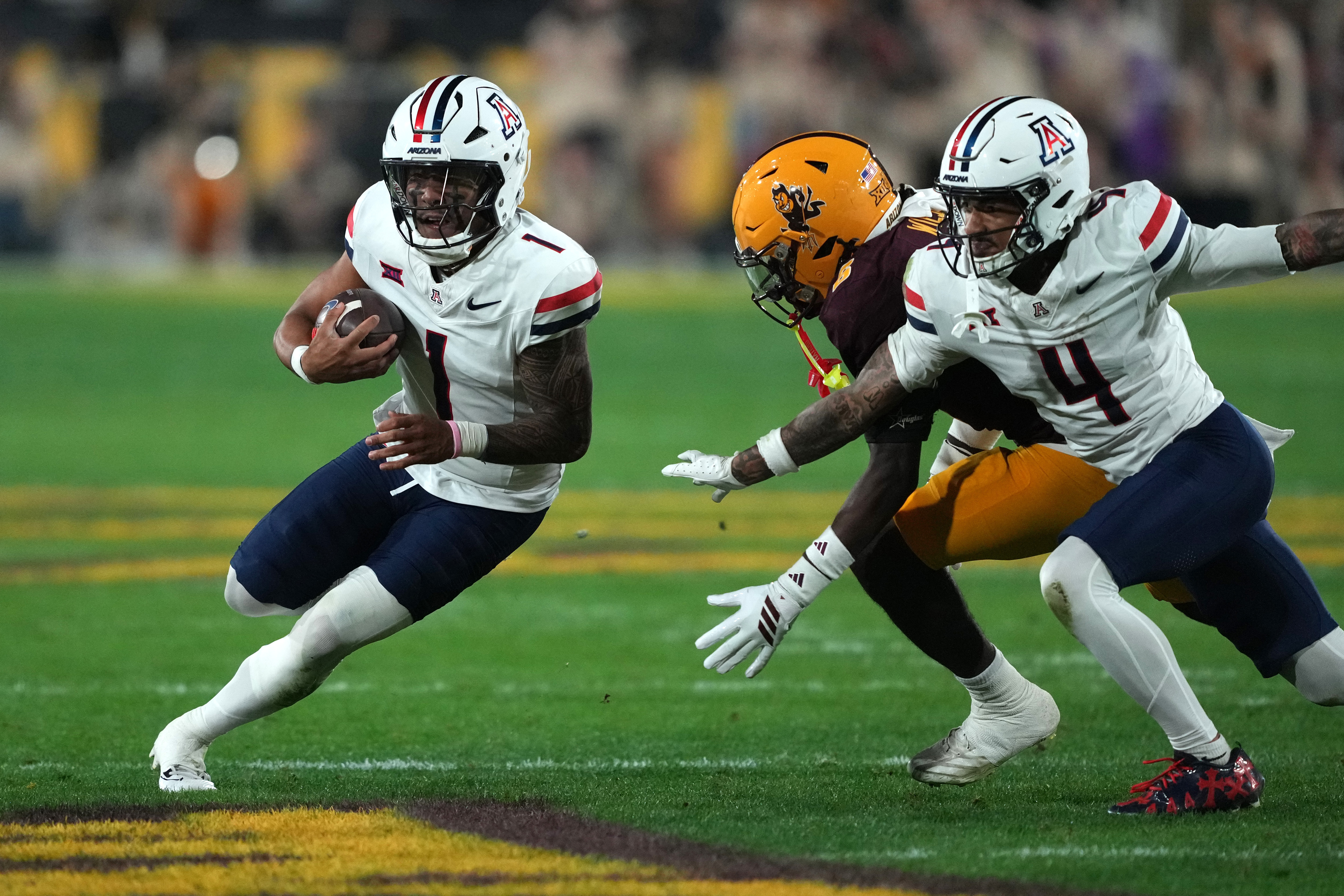 Arizona quarterback Noah Fifita (1) runs the ball against Arizona State in the first half of an NCAA college football game, Friday, Nov. 28, 2025, in Tempe, Ariz. 