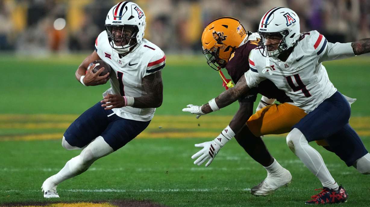 Arizona quarterback Noah Fifita (1) runs the ball against Arizona State in the first half of an NCAA college football game, Friday, Nov. 28, 2025, in Tempe, Ariz.