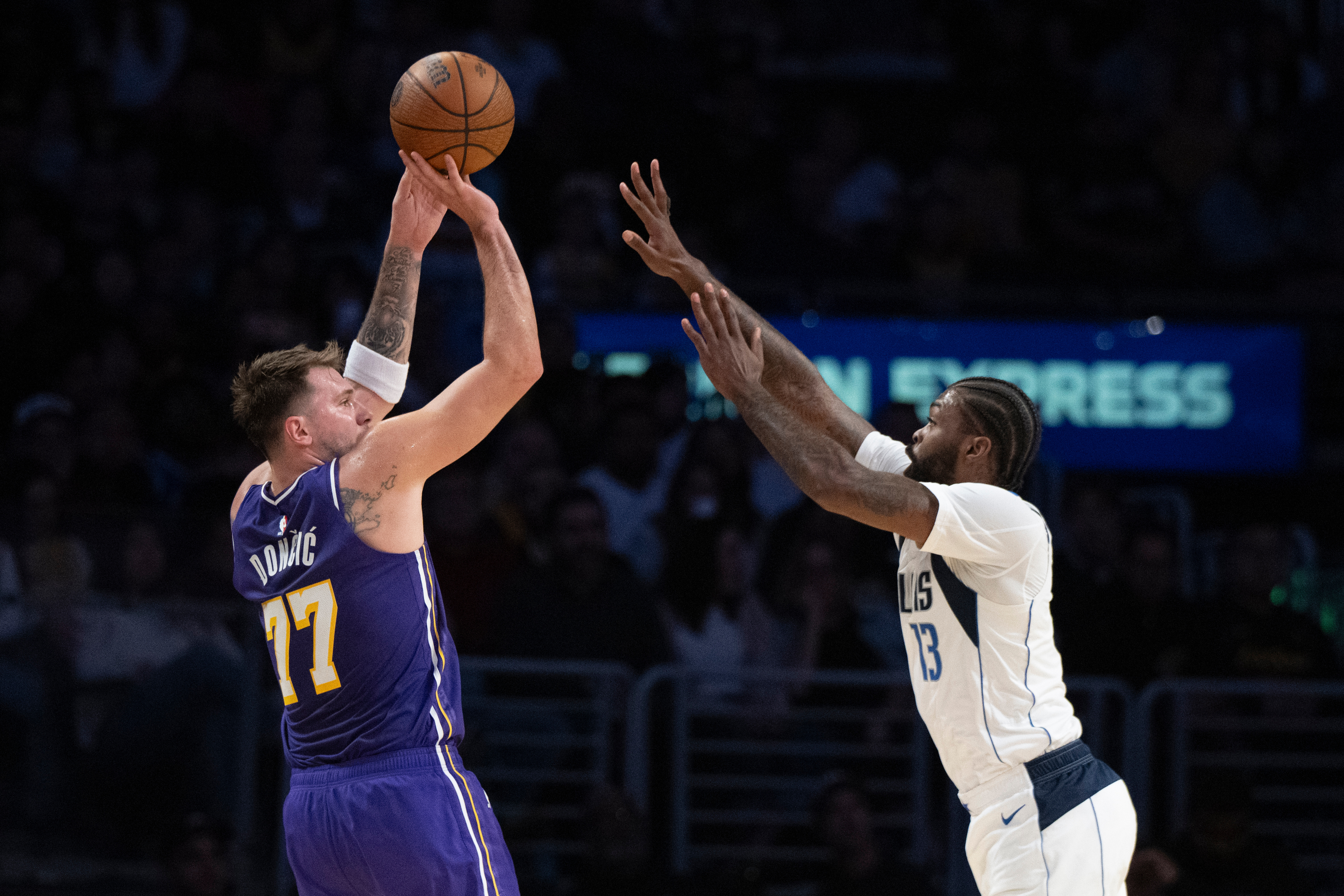 Los Angeles Lakers guard Luka Doncic (77) shoots as Dallas Mavericks forward Naji Marshall (13) defends during the first half of an NBA Cup basketball game in Los Angeles, Friday, Nov. 28, 2025.