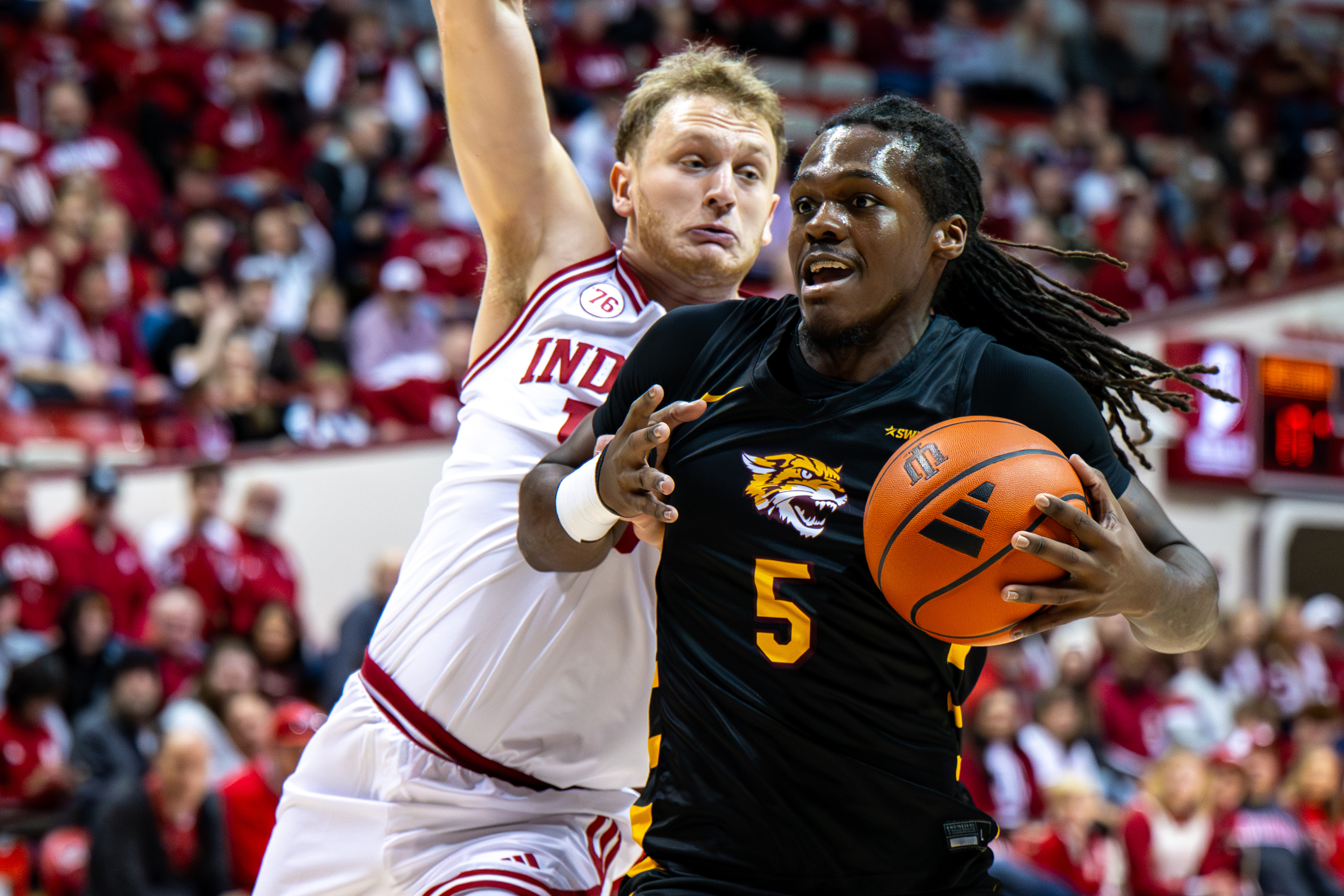 Bethune-Cookman forward Quentin Heady (5) is defended by Indiana forward Tucker Devries (12) during the first half of an NCAA college basketball game, Saturday, Nov. 29, 2025, in Bloomington, Ind. 