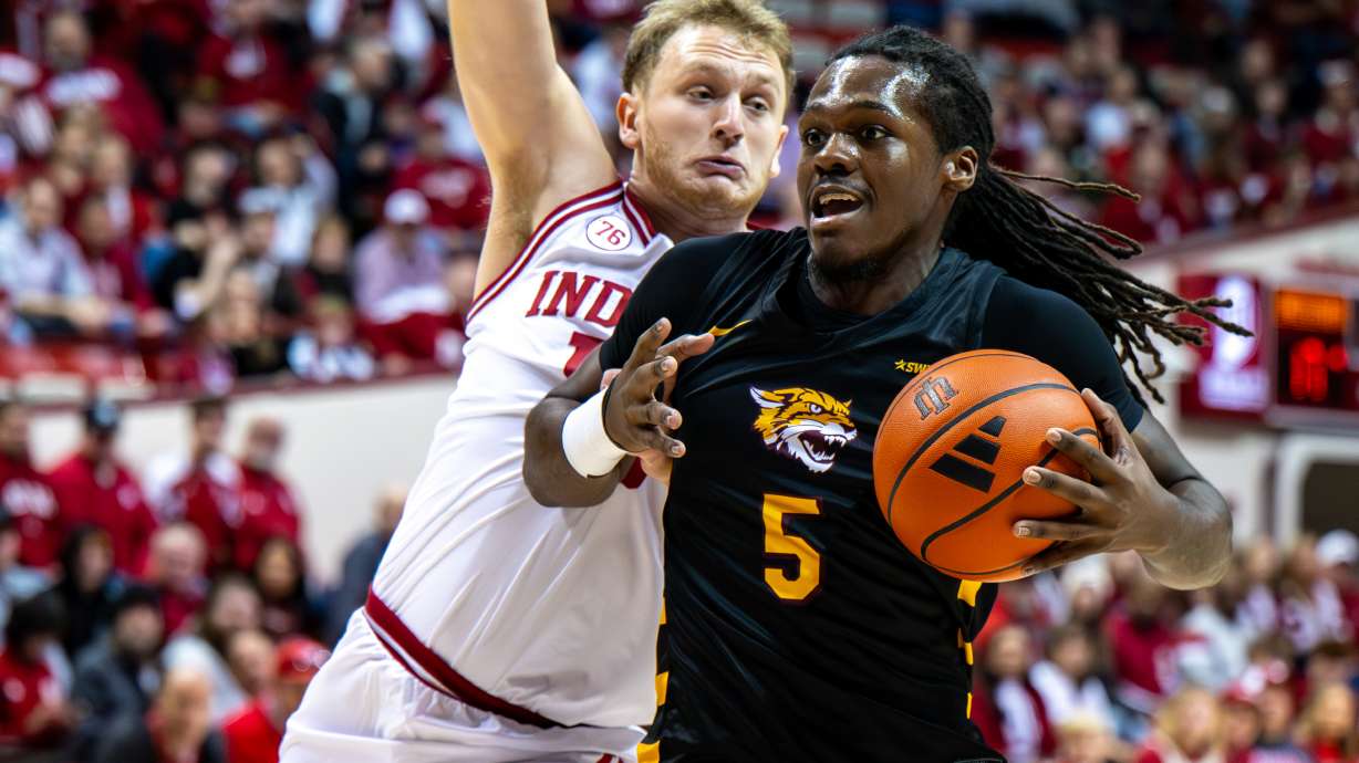 Bethune-Cookman forward Quentin Heady (5) is defended by Indiana forward Tucker Devries (12) during the first half of an NCAA college basketball game, Saturday, Nov. 29, 2025, in Bloomington, Ind.