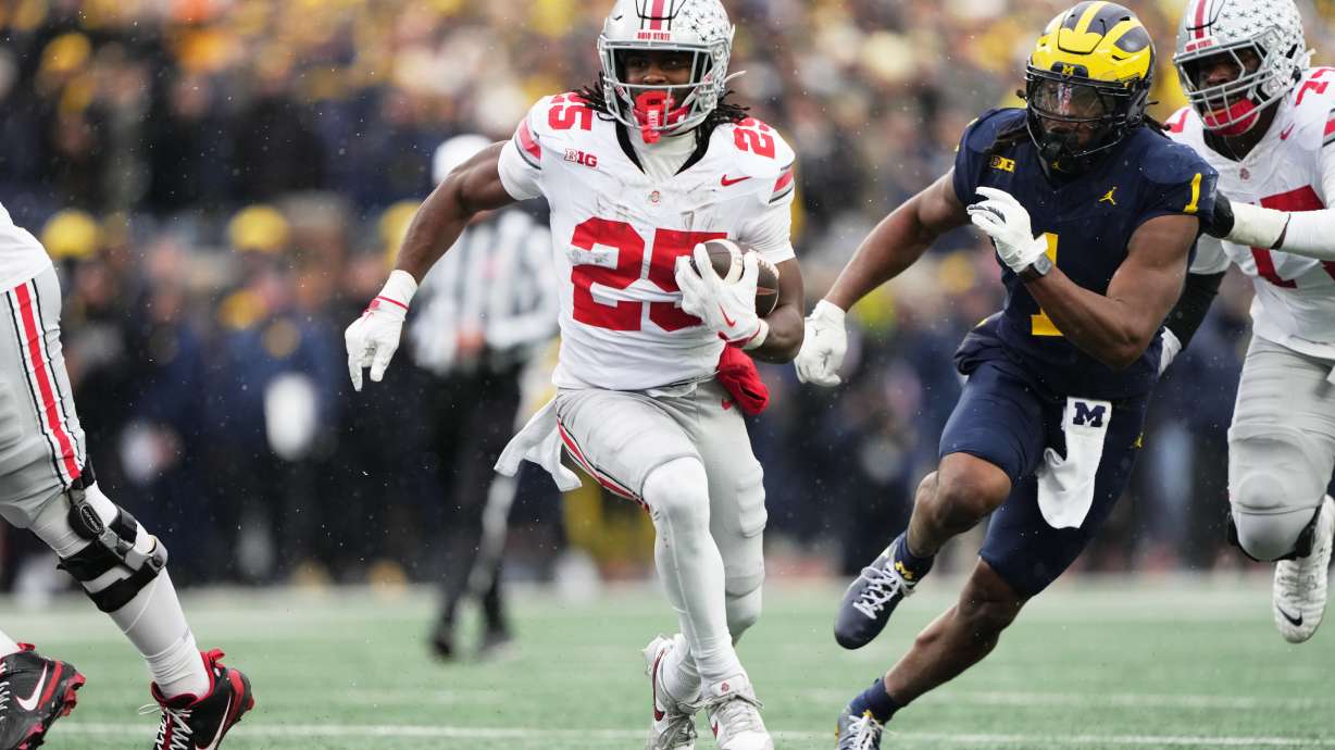 Ohio State running back Bo Jackson (25) runs the ball against Michigan linebacker Jaishawn Barham (1) during the first half of an NCAA college football game, Saturday, Nov. 29, 2025, in Ann Arbor, Mich.