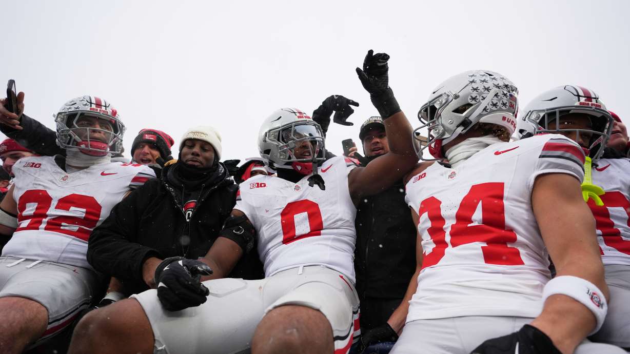 Ohio State Buckeyes defensive end Caden Curry, linebacker Sonny Styles, and wide receiver Brennen Schramm, from left, celebrate after the team's win against Michigan in an NCAA college football game, Saturday, Nov. 29, 2025, in Ann Arbor, Mich.