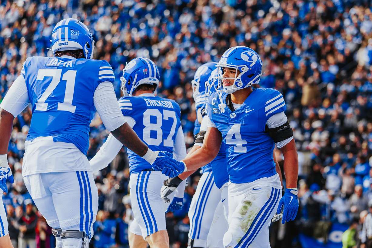 BYU's LJ Martin (4) celebrates a touchdown with teammate Isaiah Jatta during a Big 12 football game against UCF, Saturday, Nov. 29, 2025 at LaVell Edwards Stadium in Provo, Utah.