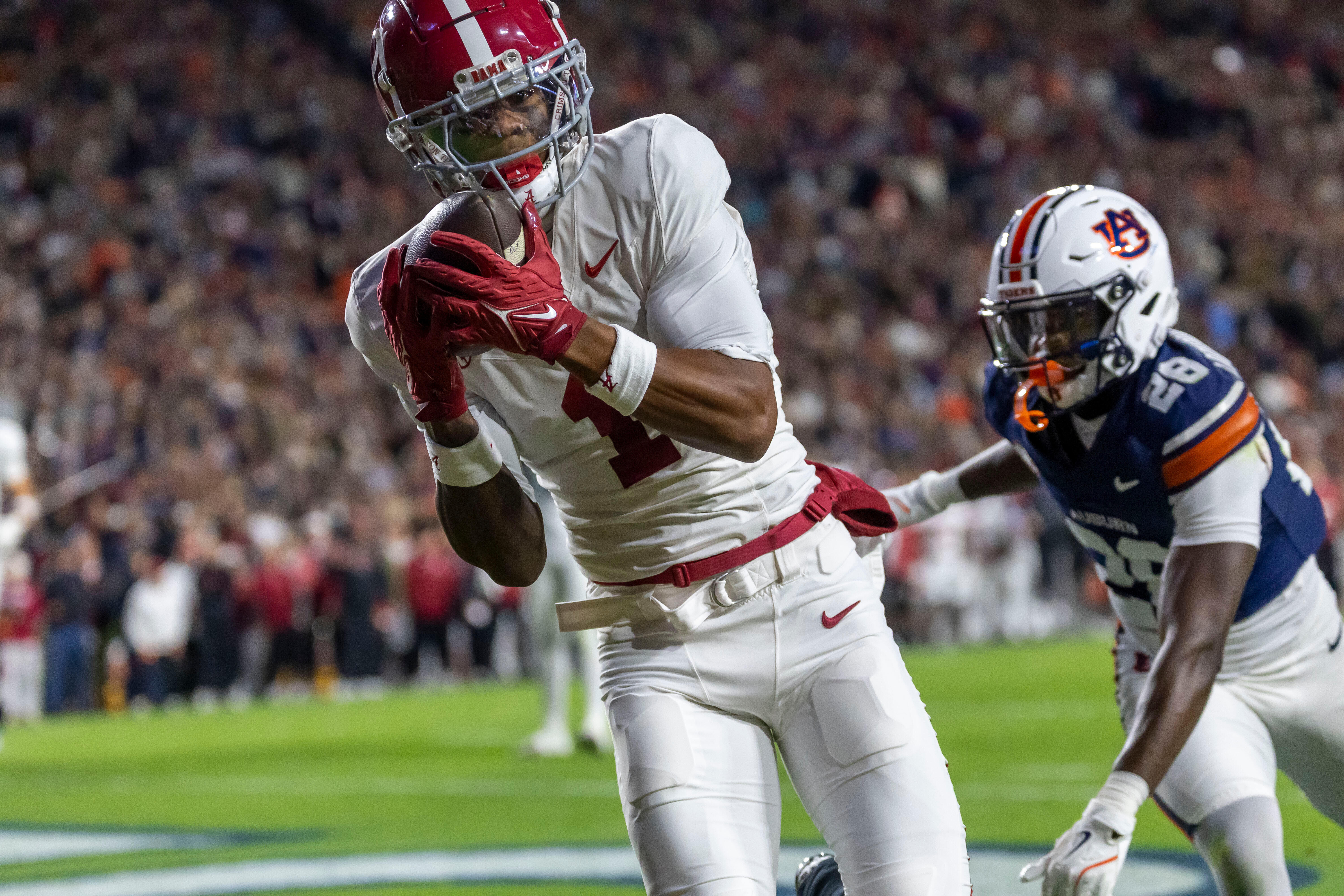 Alabama wide receiver Isaiah Horton, left, grabs a touchdown pass in front of Auburn defensive back Kensley Louidor-Faustin (28) during the first half of an NCAA college football game, Saturday, Nov. 29, 2025, in Auburn, Ala. 
