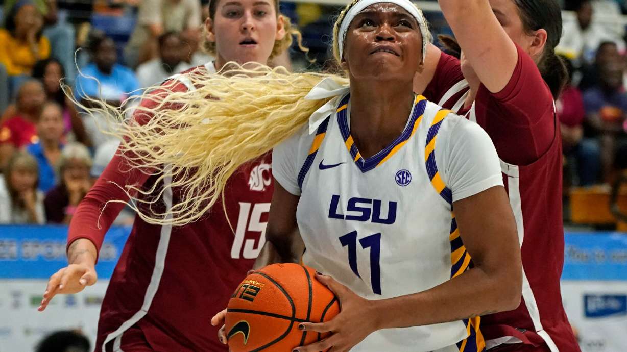 LSU guard ZaKiyah Johnson, center, drives for a shot between Washington State defenders Keandra Koorits, left, and Malia Ruud during the first quarter of their Reef Division championship game at the Paradise Jam NCAA college basketball tournament in St. Thomas, U.S. Virgin Islands, Saturday, Nov. 29, 2025.