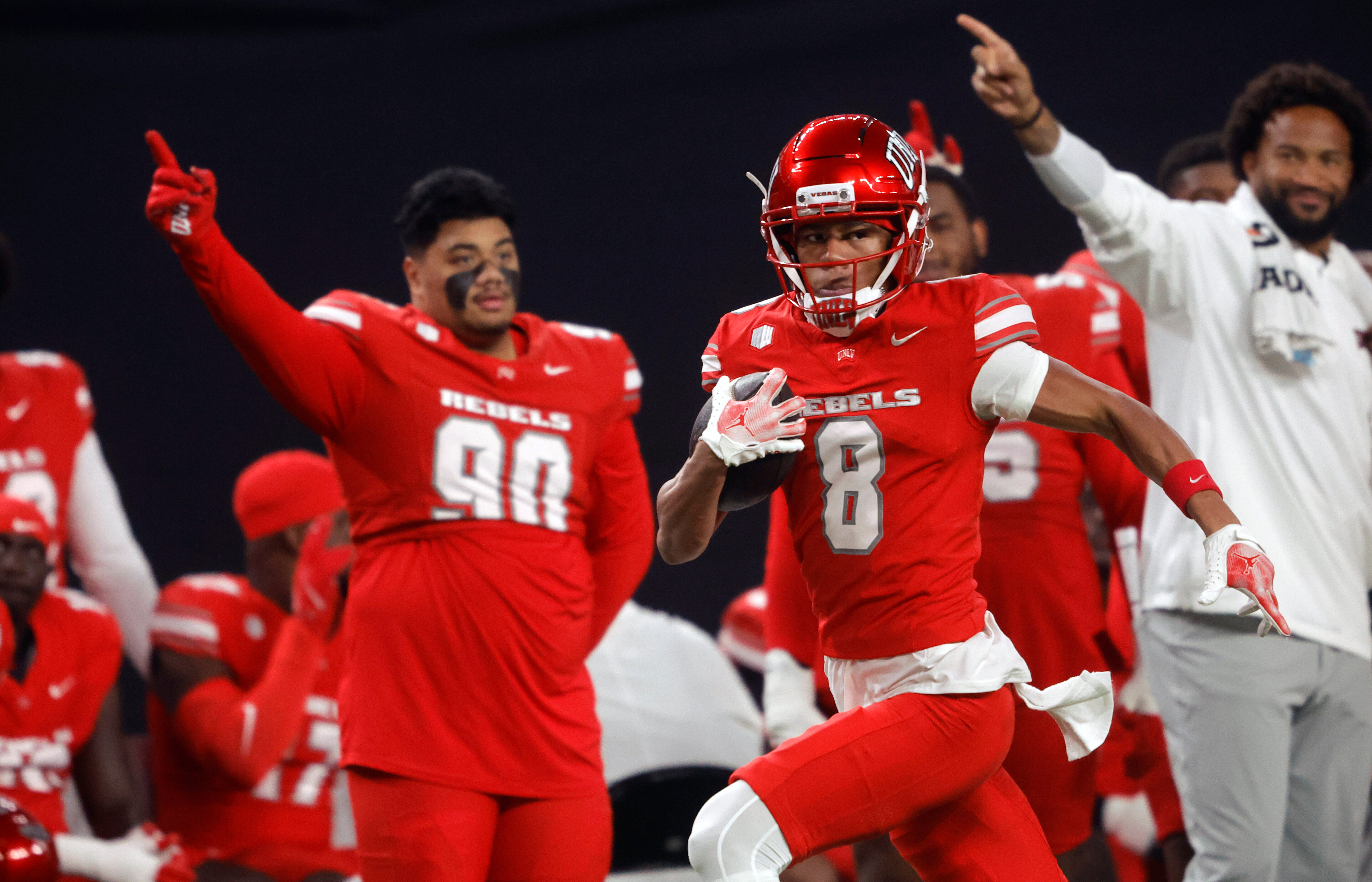 UNLV wide receiver Taeshaun Lyons (8) runs down the UNLV sideline for a touchdown after a pass reception during the first half of an NCAA college football game against Hawaii Friday, Nov. 21, 2025, in Las Vegas. 
