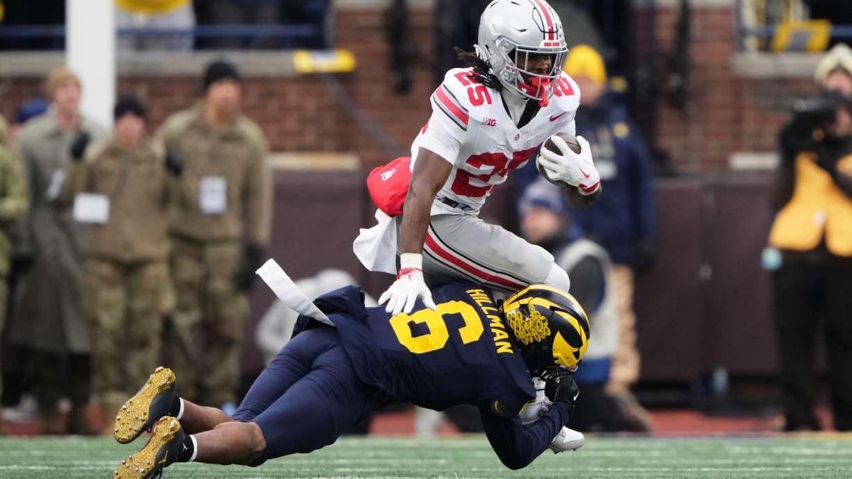 Ohio State running back Bo Jackson, top, is tackled by Michigan defensive back Brandyn Hillman during the first half of an NCAA college football game, Saturday, Nov. 29, 2025, in Ann Arbor, Mich.