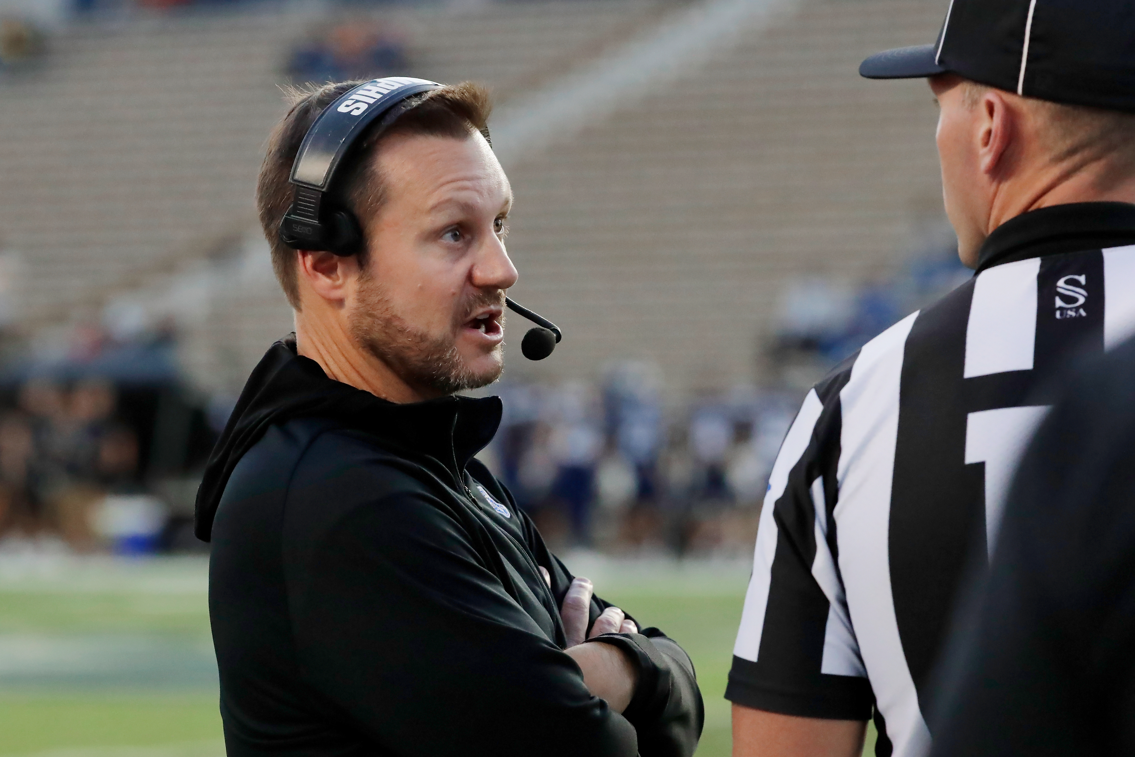 Memphis head coach Ryan Silverfield, left, talks with an official after a penalty during the first half of an NCAA college football game against Rice, Friday, Oct. 31, 2025, in Houston. 