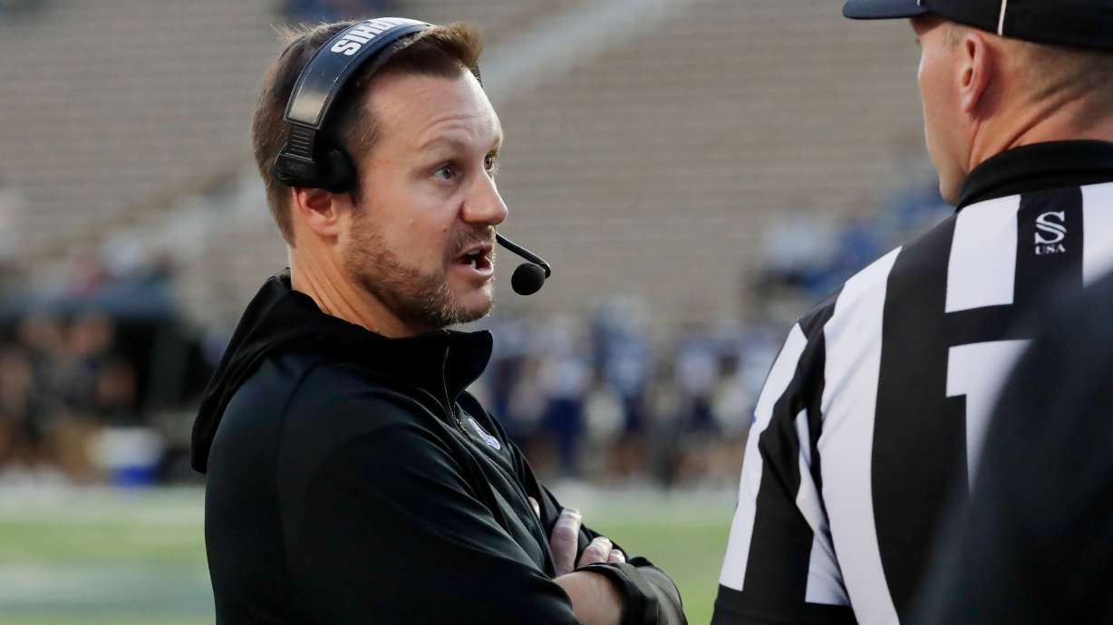 Memphis head coach Ryan Silverfield, left, talks with an official after a penalty during the first half of an NCAA college football game against Rice, Friday, Oct. 31, 2025, in Houston.