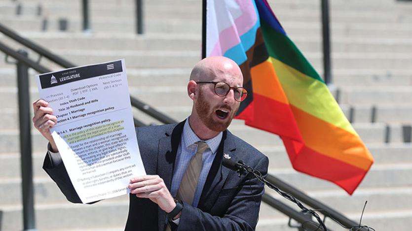 Derek Kitchen holds a copy of Utah code regarding marriage recognition policy during a press conference about same-sex marriage on June 7, 2022. Kitchen has announced his candidacy for Utah's new first congressional district.