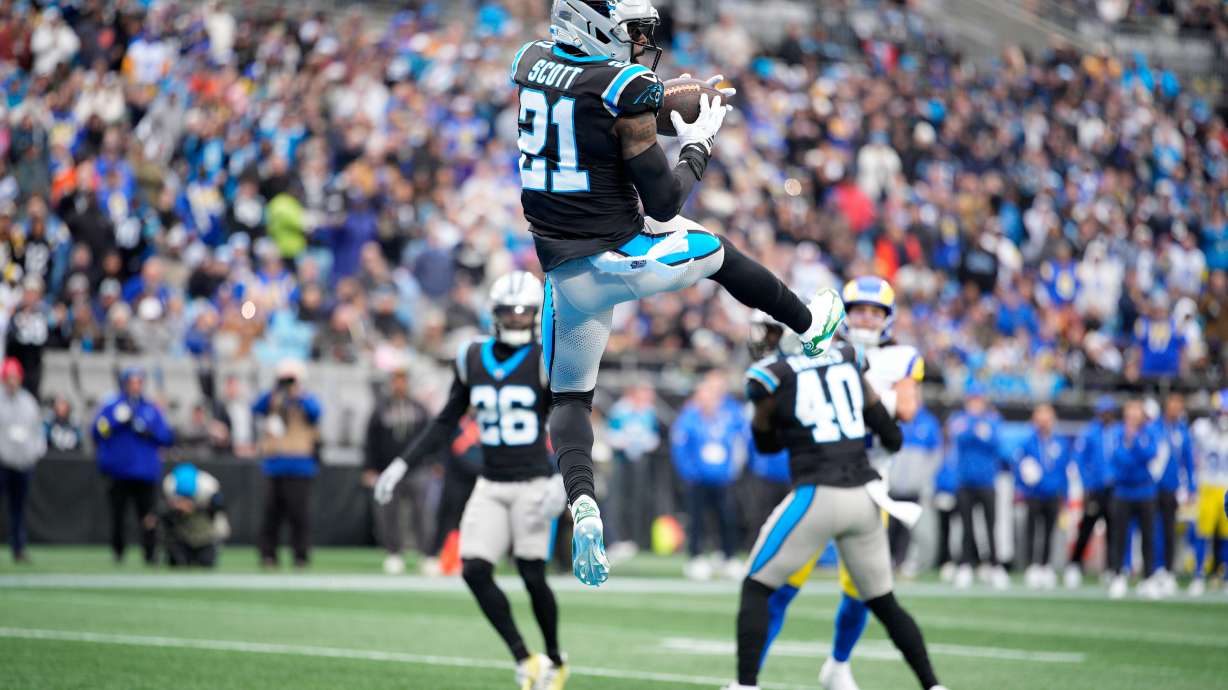 Carolina Panthers safety Nick Scott intercepts of pass against the Los Angeles Rams during the first half of an NFL football game, Sunday, Nov. 30, 2025, in Charlotte, N.C.