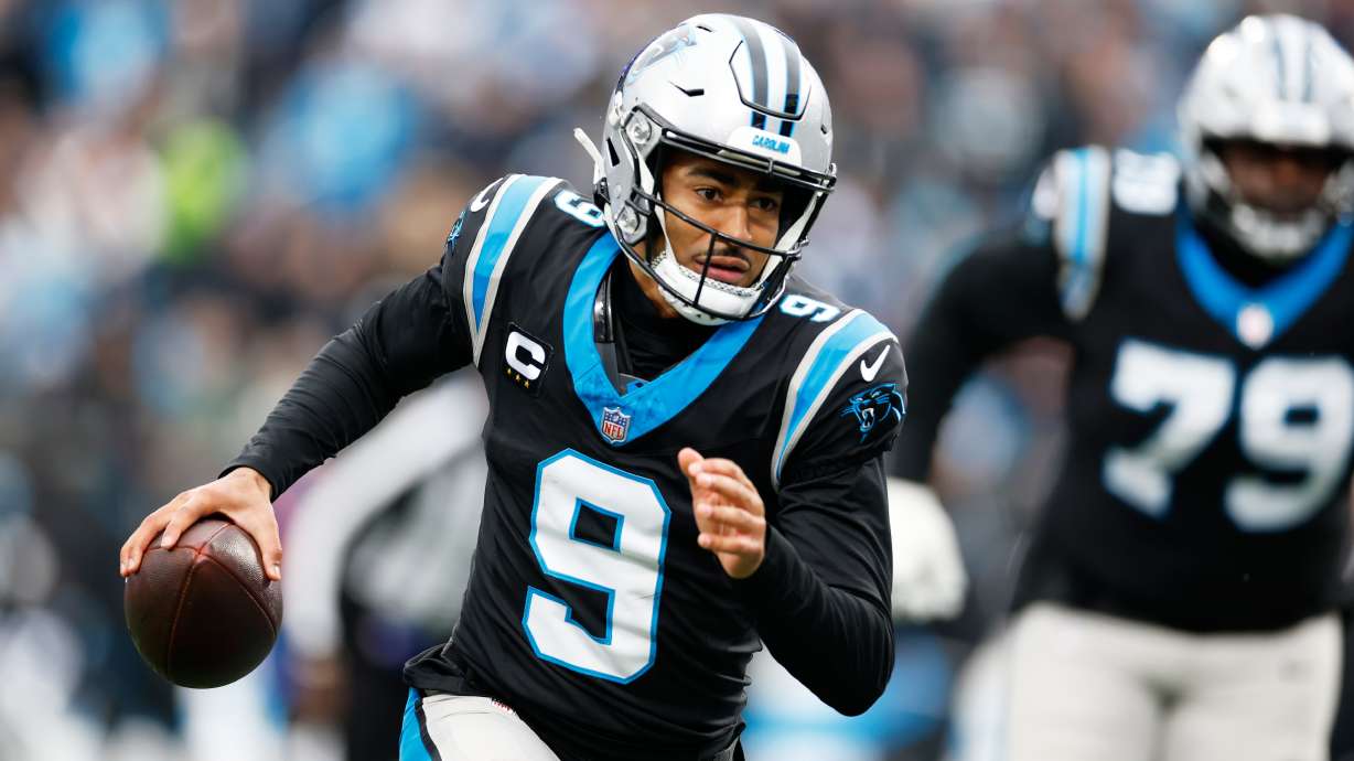 Carolina Panthers quarterback Bryce Young runs against the Los Angeles Rams during the first half of an NFL football game, Sunday, Nov. 30, 2025, in Charlotte, N.C.