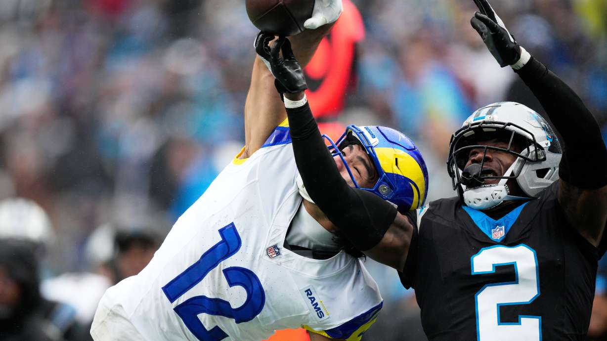 Los Angeles Rams wide receiver Puka Nacua catches a pass over Carolina Panthers cornerback Mike Jackson during the second half of an NFL football game, Sunday, Nov. 30, 2025, in Charlotte, N.C.