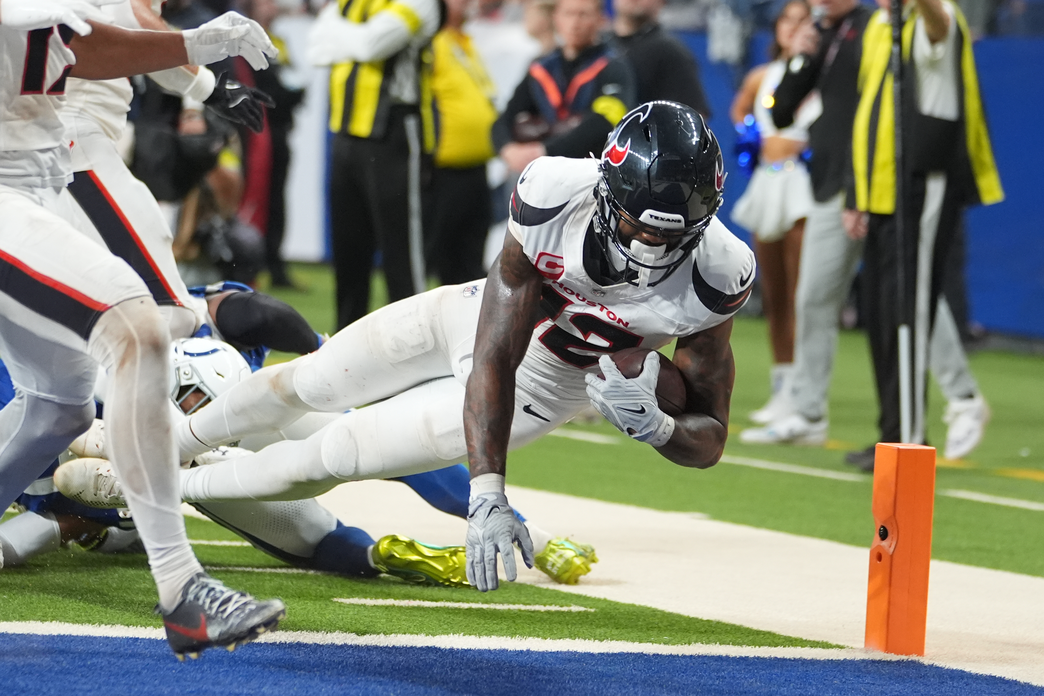 Houston Texans' Nico Collins (12) scores a touchdown against the Indianapolis Colts during the second half of an NFL football game Sunday, Nov. 30, 2025, in Indianapolis. 