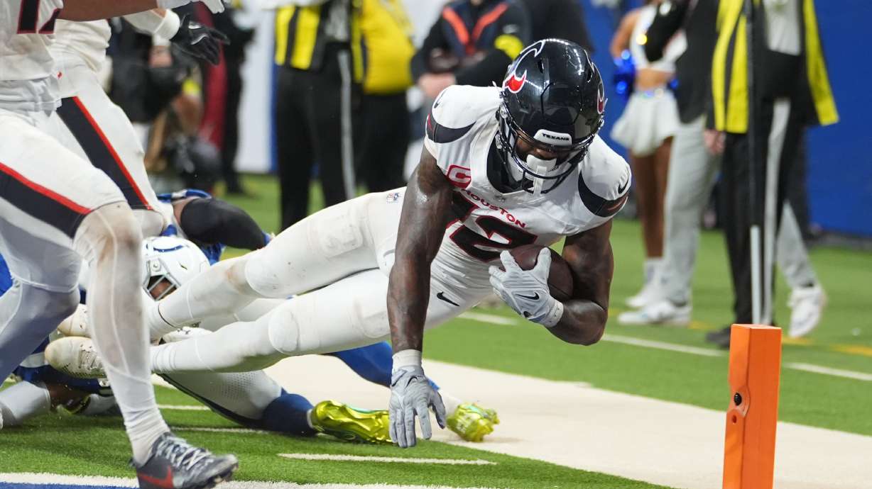 Houston Texans' Nico Collins (12) scores a touchdown against the Indianapolis Colts during the second half of an NFL football game Sunday, Nov. 30, 2025, in Indianapolis.