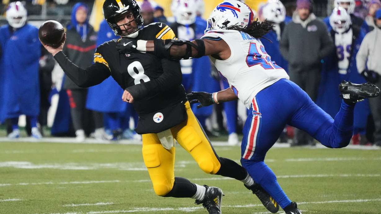 Pittsburgh Steelers quarterback Aaron Rodgers (8) throws against Buffalo Bills linebacker Dorian Williams (42) during the first half of an NFL football game Sunday, Nov. 30, 2025, in Pittsburgh.