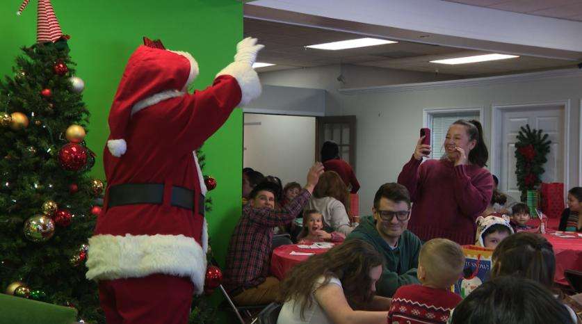 Santa Claus waves during a party Sunday in Layton for military families in Utah.