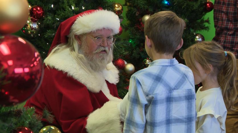 Santa Claus visits with two children during a party in Layton, Sunday, for military families in Utah.