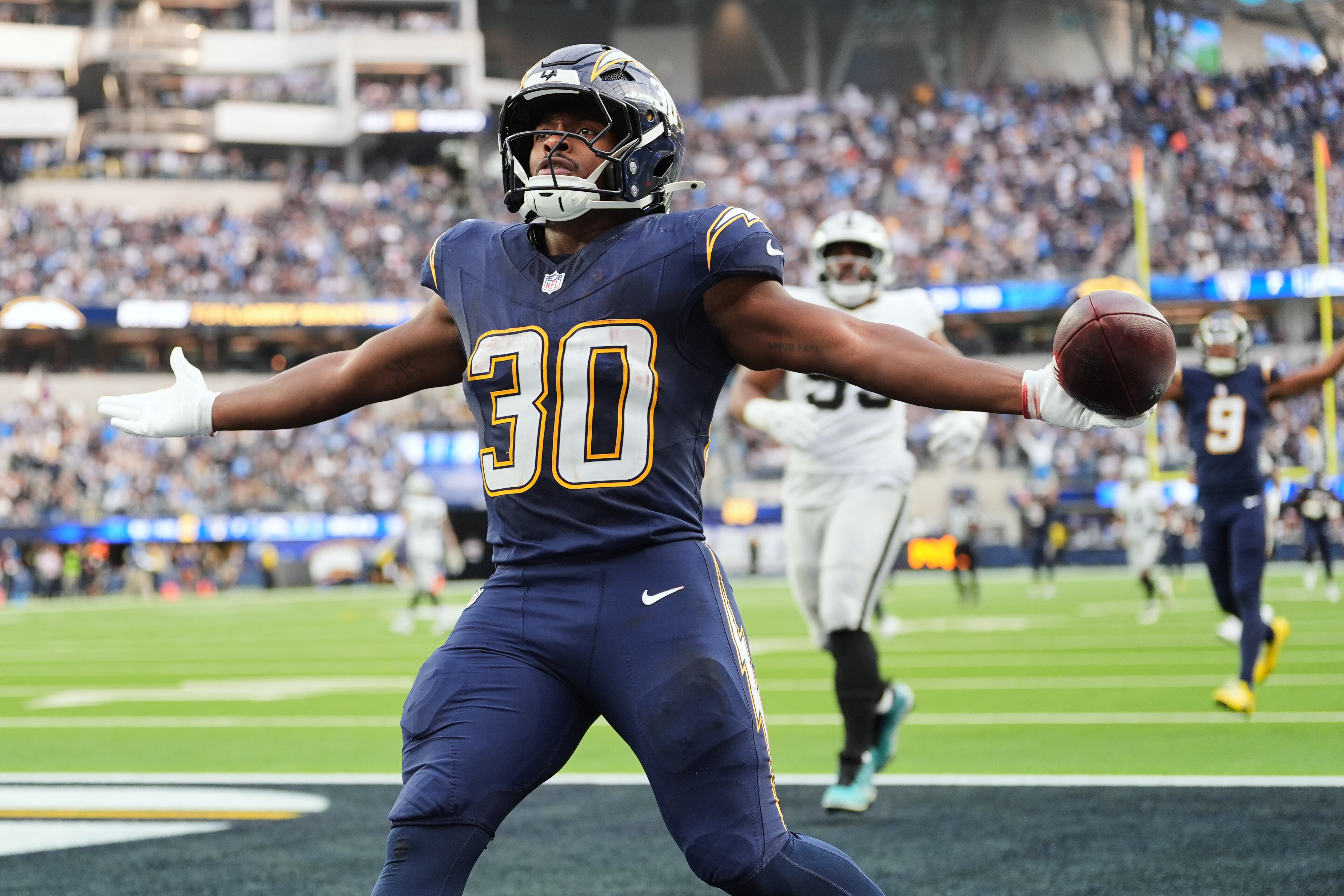 Los Angeles Chargers running back Kimani Vidal (30) celebrates after scoring a touchdown during the second half of an NFL football game against the Las Vegas Raiders, Sunday, Nov. 30, 2025, in Inglewood, Calif.