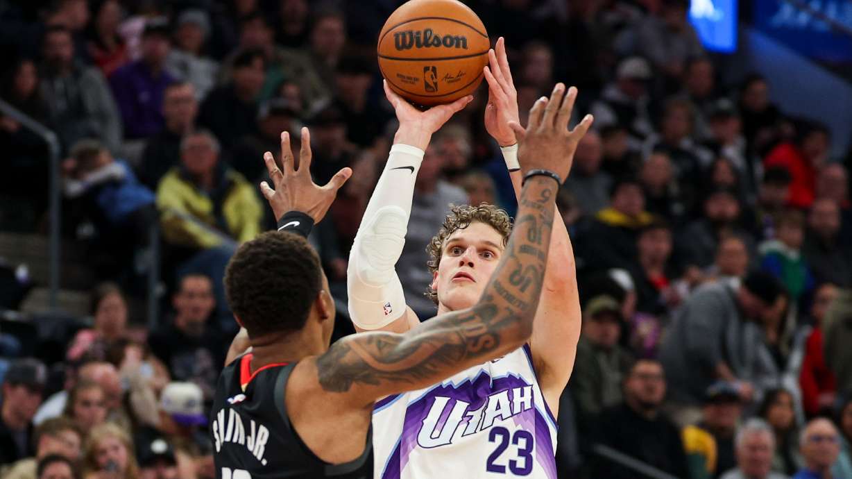 Utah Jazz forward Lauri Markkanen (23) shoots a 3-pointer over Houston Rockets forward Jabari Smith Jr. (10) during the second half of an NBA game at the Delta Center in Salt Lake City on Sunday, Nov. 30, 2025.