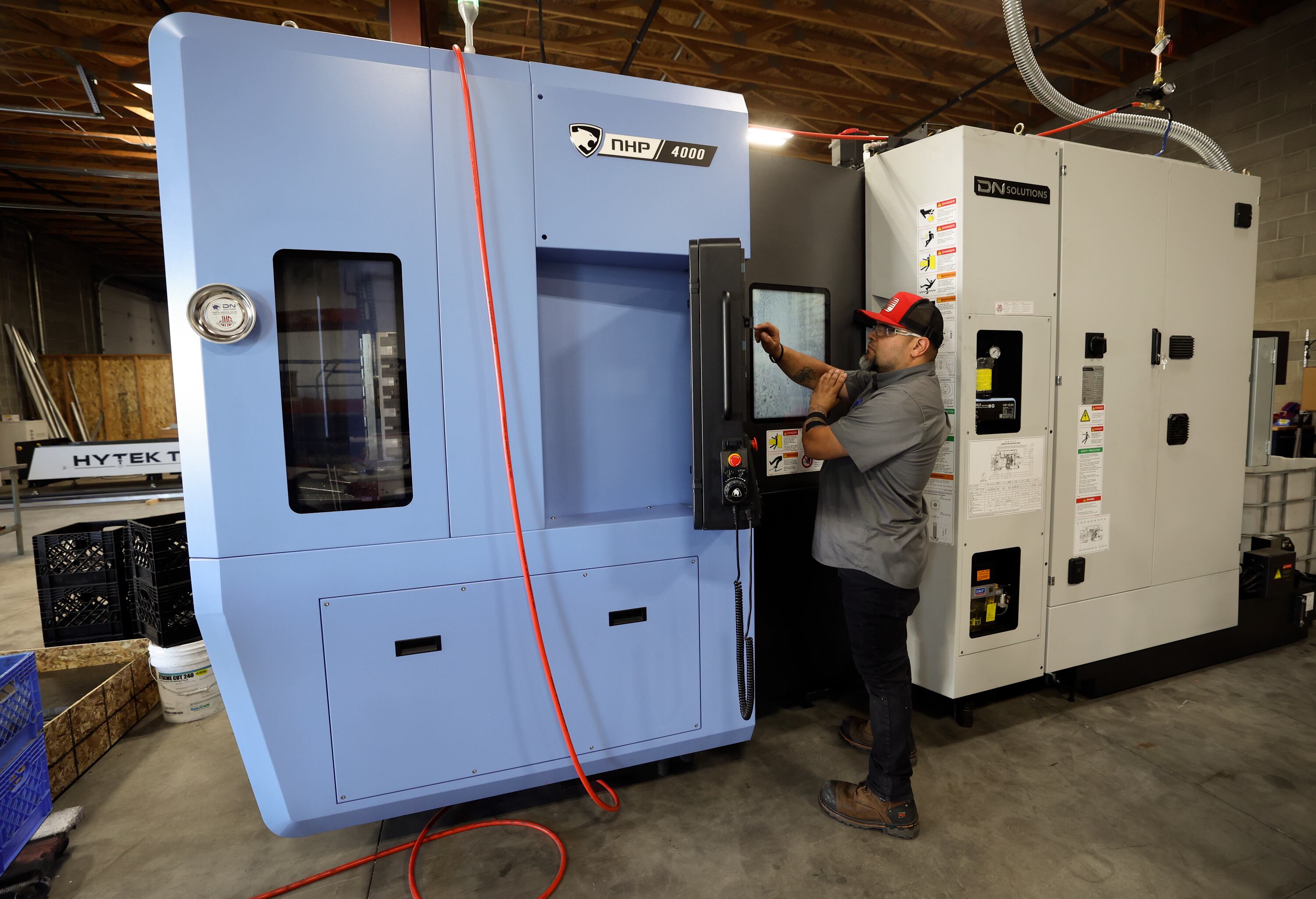 Mike Garcia, Murphy Door machinist lead, makes hinge plates at Murphy Door in West Haven on Oct. 21.
