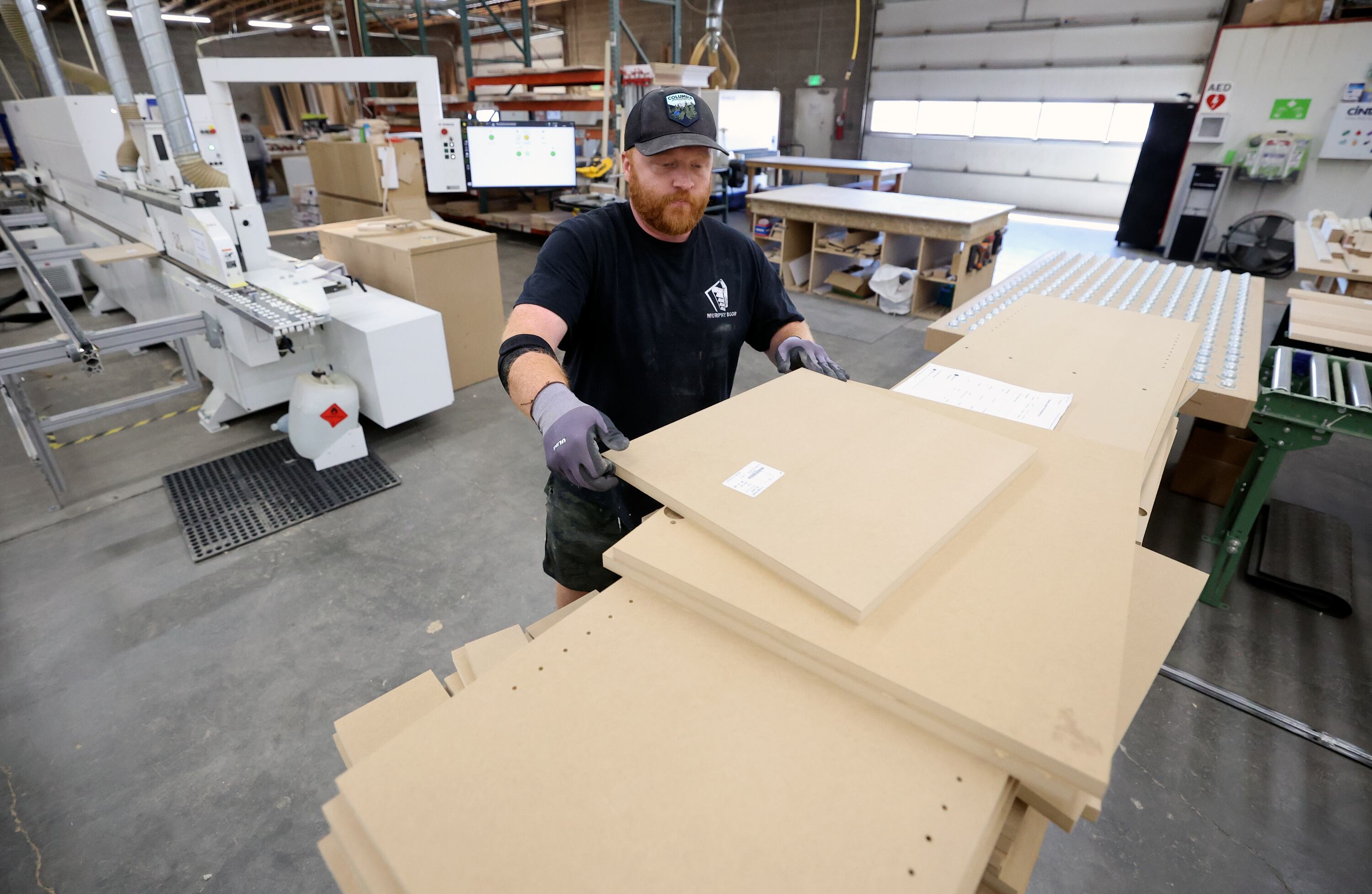 Corbin Spaulding, Murphy Door mill worker, bands cabinets at Murphy Door in West Haven on Oct. 21.