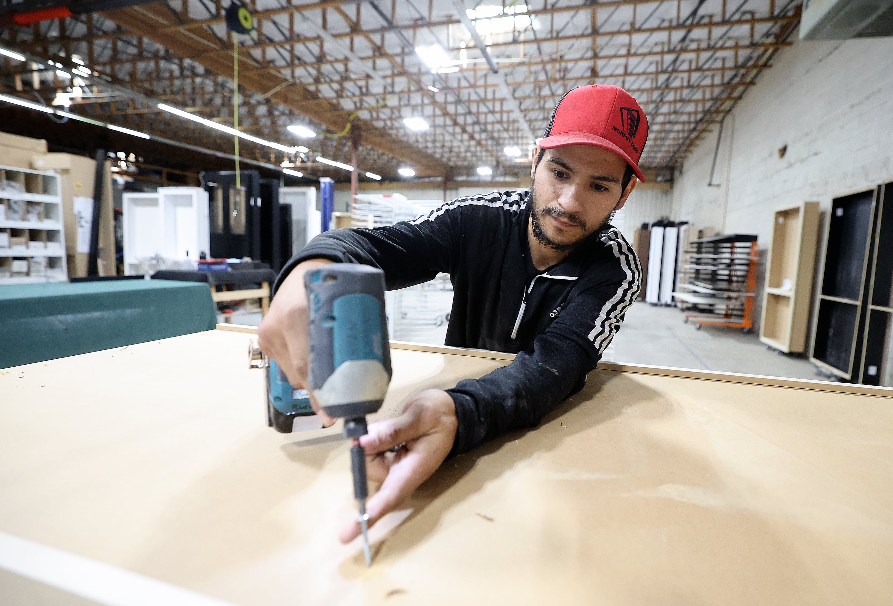 Diego Amador, Murphy Door builder, builds a bookcase door at Murphy Door in West Haven on Oct. 21.
