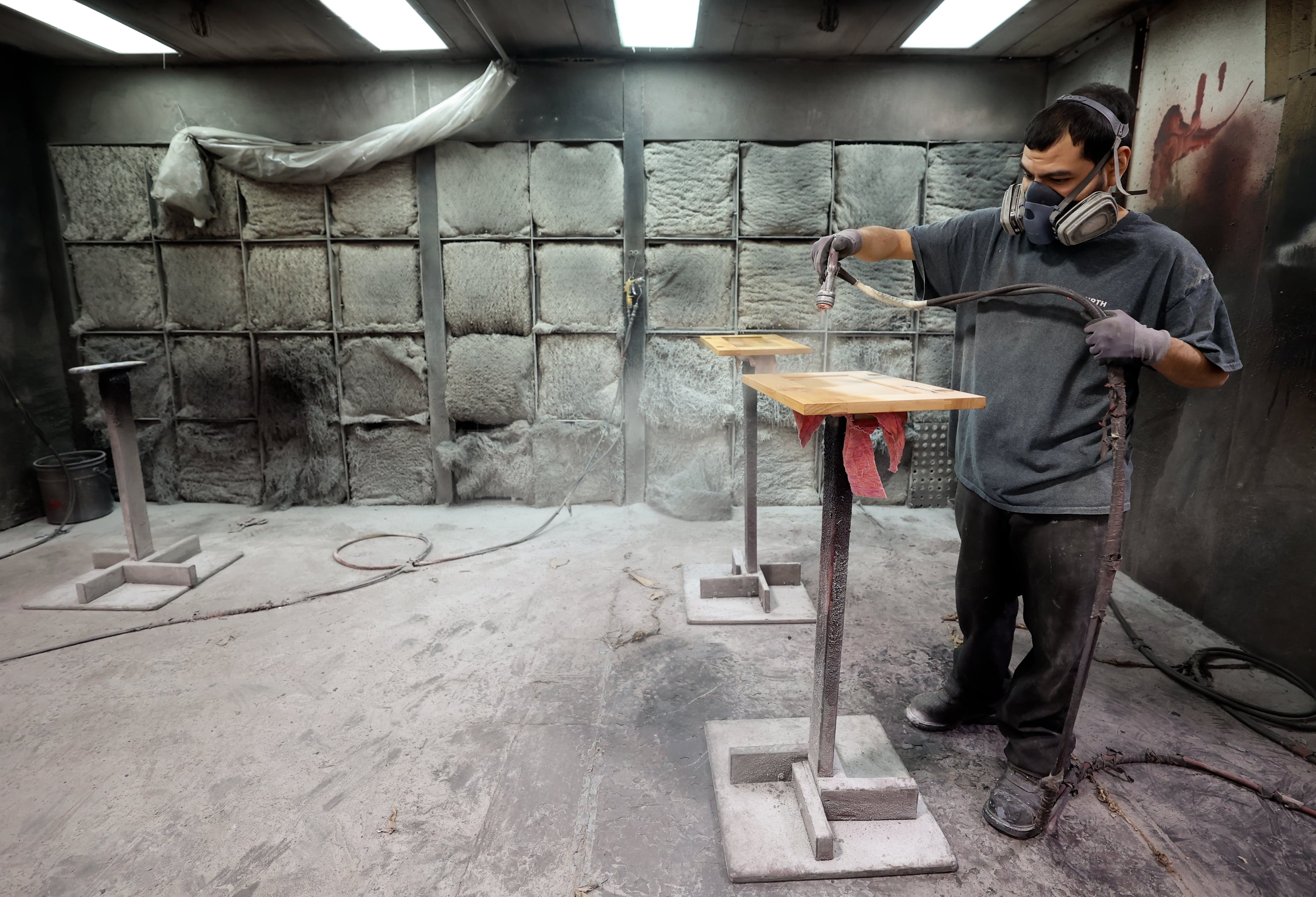 Ivan Albarran, Murphy Door painter, stains cabinets at Murphy Door in West Haven on Oct. 21.
