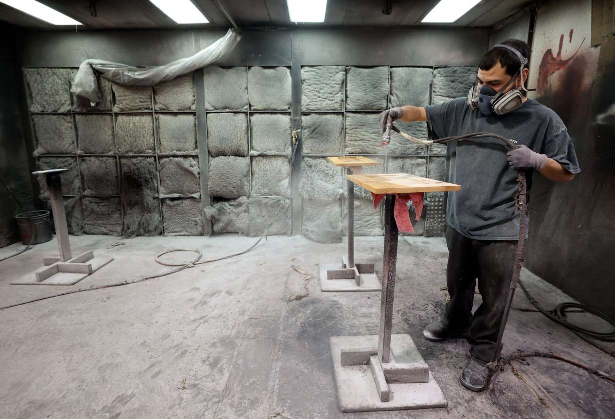 Ivan Albarran, Murphy Door painter, stains cabinets at Murphy Door in West Haven on Oct. 21.