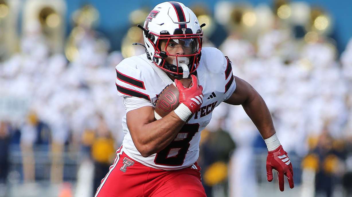 Texas Tech running back Cameron Dickey (8) runs against West Virginia during the first half of an NCAA college football game Saturday, Nov. 29, 2025, in Morgantown, W.Va.