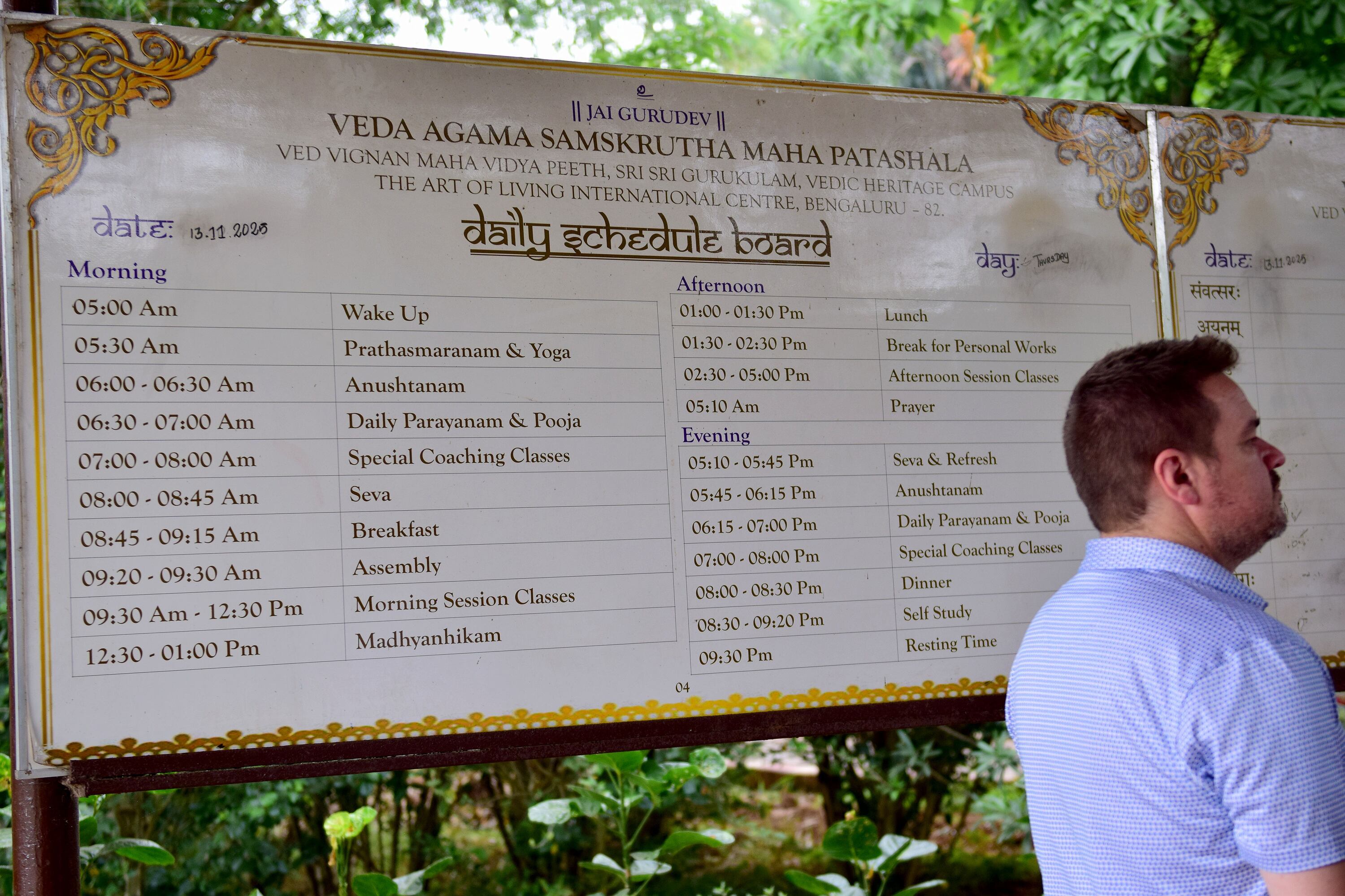 Utah state Rep. Matt MacPherson, R-West Valley City, stands in front of the daily schedule board for the residential school at the Art of Living International Center near Bangalore, India. Here, young boys study and preserve ancient Hindu scriptures like the Vegas and Agamas and become priests.