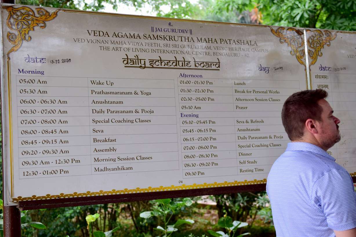 Utah state Rep. Matt MacPherson, R-West Valley City, stands in front of the daily schedule board for the residential school at the Art of Living International Center near Bangalore, India. Here, young boys study and preserve ancient Hindu scriptures like the Vegas and Agamas and become priests.