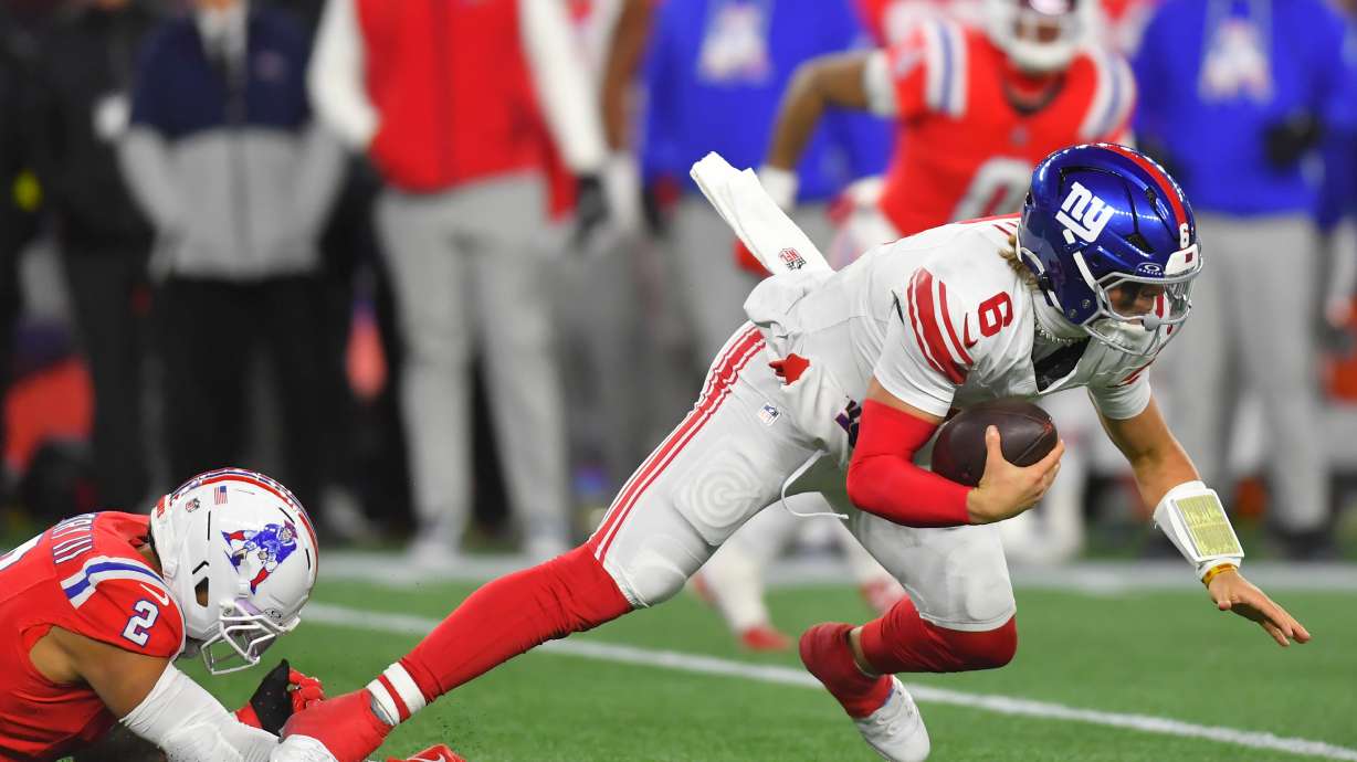 New York Giants quarterback Jaxson Dart (6) is sacked by New England Patriots linebacker Harold Landry III (2) during the second half of an NFL football game Monday, Dec. 1, 2025, in Foxborough, Mass.