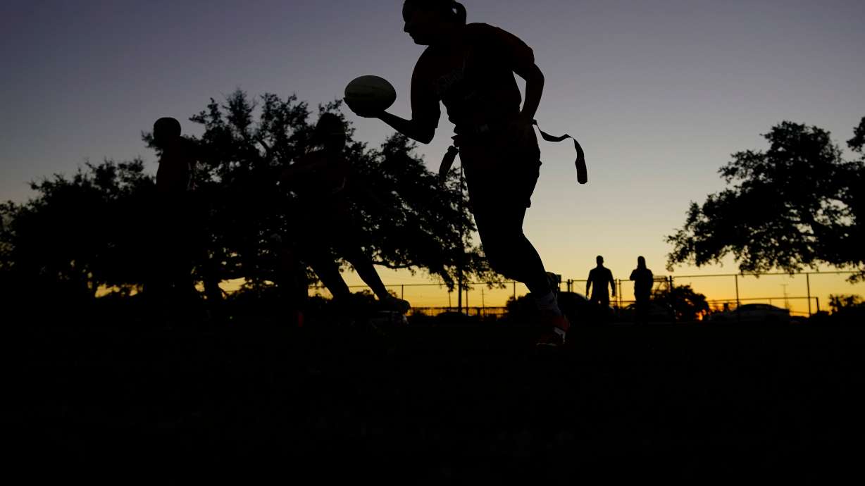 FILE - Players run drills during a practice with Texas Fury, an all-girls flag football select travel team, Dec. 10, 2023, in Austin, Texas.