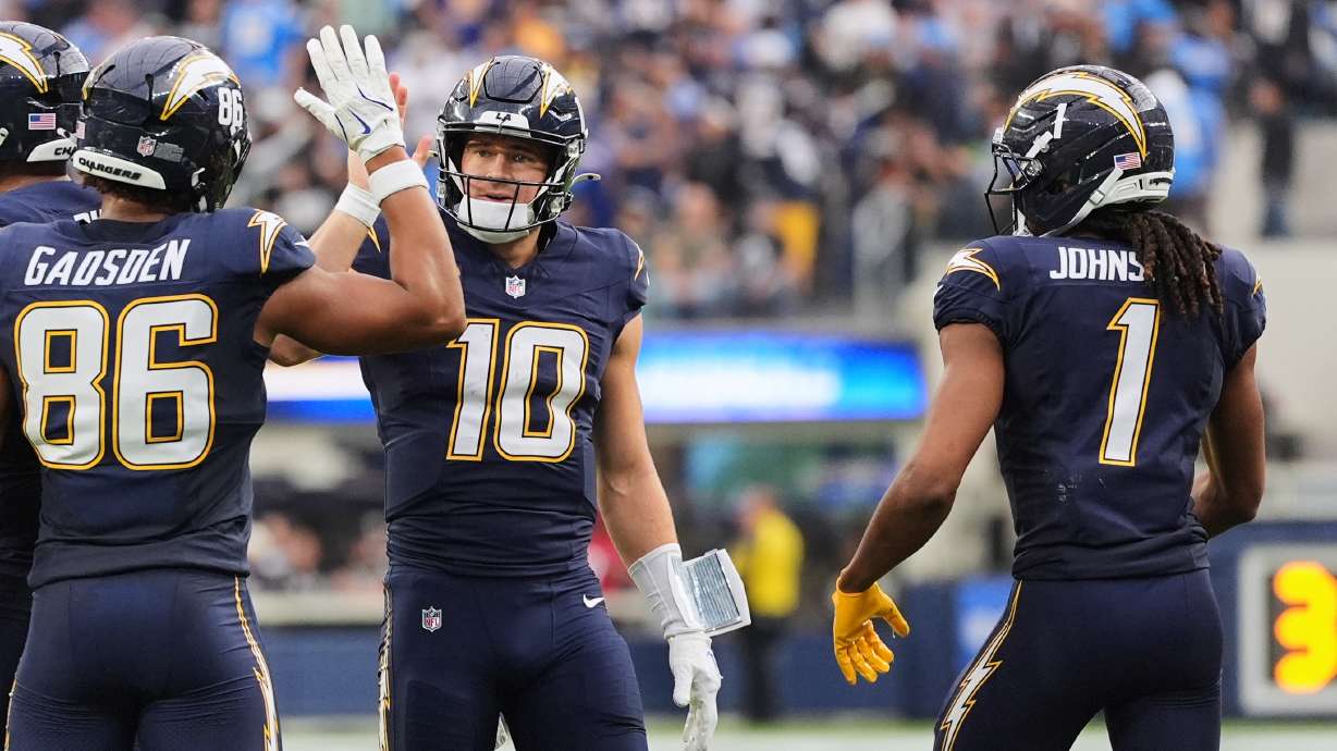 Los Angeles Chargers quarterback Justin Herbert (10) celebrates with tight end Oronde Gadsden II (86) after throwing a touchdown during the second half of an NFL football game against the Las Vegas Raiders, Sunday, Nov. 30, 2025, in Inglewood, Calif.