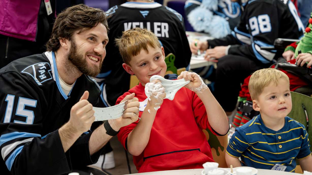 Utah Mammoth center Alexander Kerfoot poses with Teagan and Declan Harvey at Primary Children’s Hospital Nov. 25. Utah Jazz and Mammoth members will help pay for groceries and other essentials as part of "Pay It Forward Day" next week.