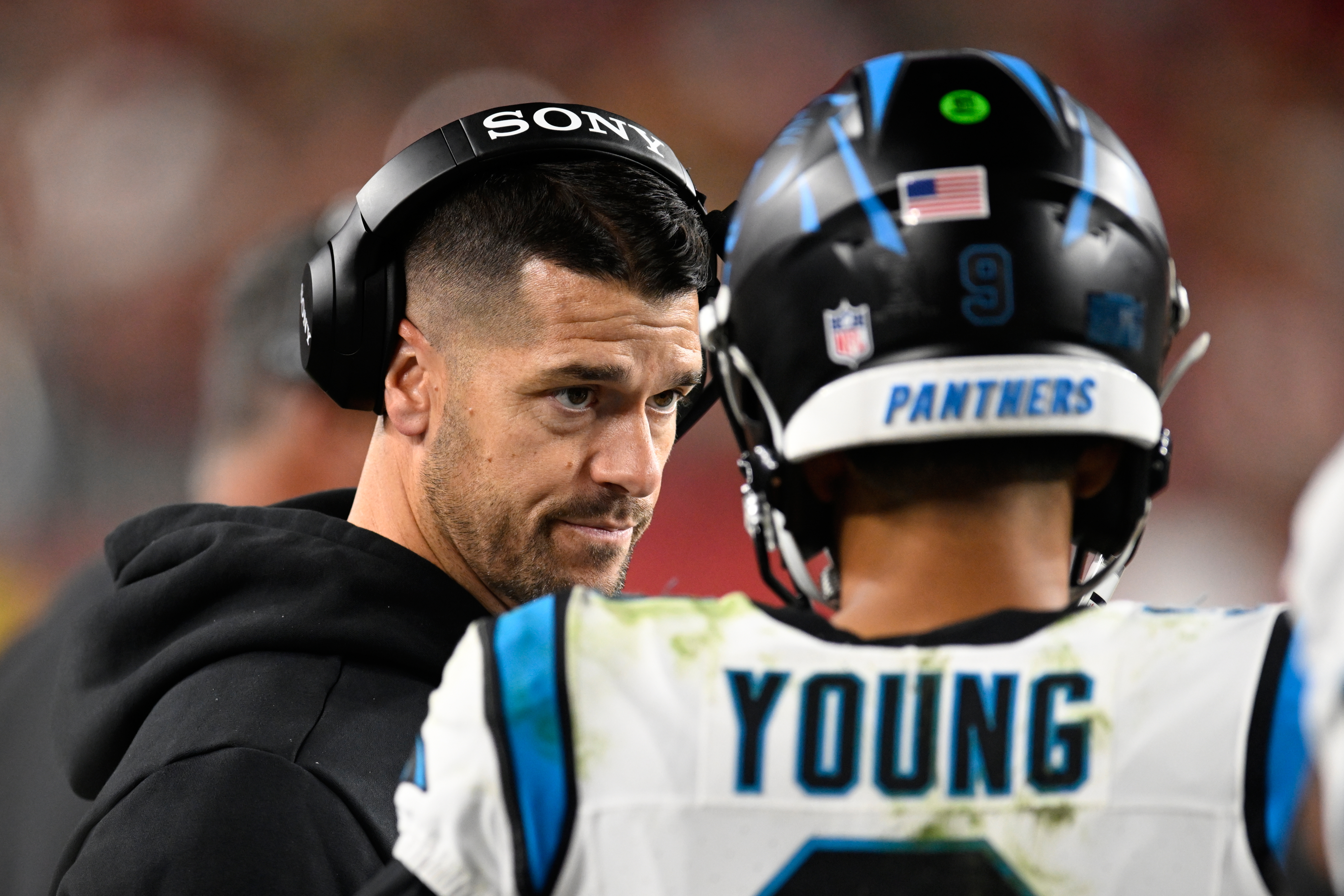 Carolina Panthers head coach Dave Canales talks with quarterback Bryce Young during the first half an NFL football game against the San Francisco 49ers, Monday, Nov. 24, 2025, in Santa Clara, Calif.