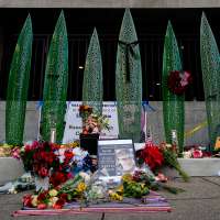 Man charged in National Guard shooting pleads not guilty in court appearance from hospital bed