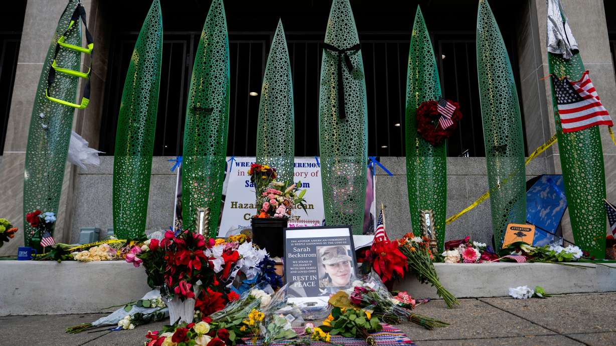 A makeshift memorial for U.S. Army Spc. Sarah Beckstrom and U.S. Air Force Staff Sgt. Andrew Wolfe is seen outside of Farragut West Station, near the site where the two National Guard members were shot, Monday, in Washington.