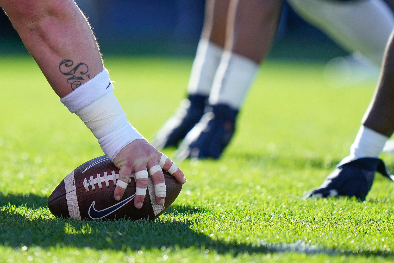 Players line up at the line of scrimmage during the first half of an NCAA college football game in East Hartford, Conn., Saturday, Nov. 12, 2022. 